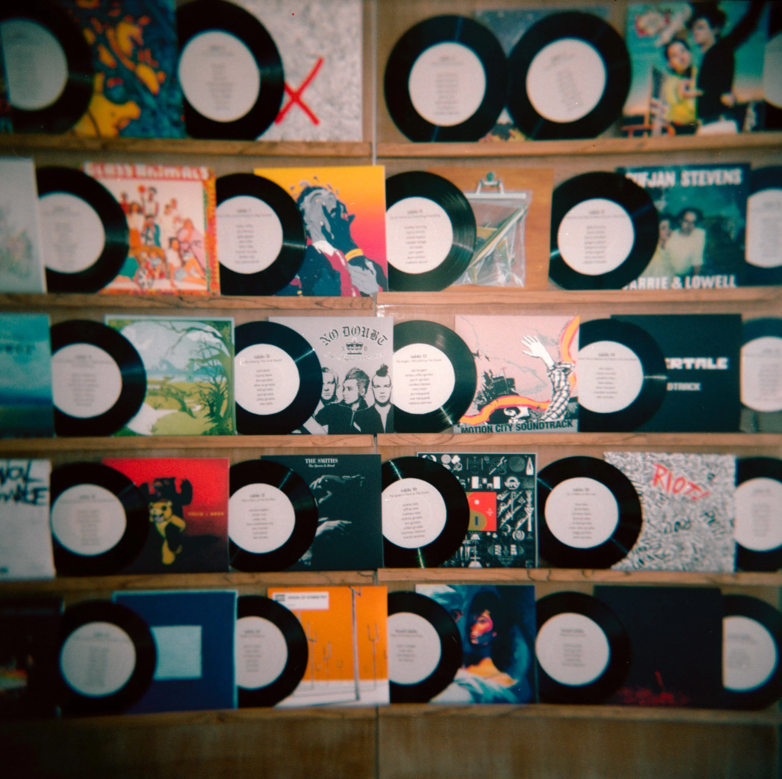 LBW60-wedding-reception-table-assignments-vinyl-records-wall.jpg