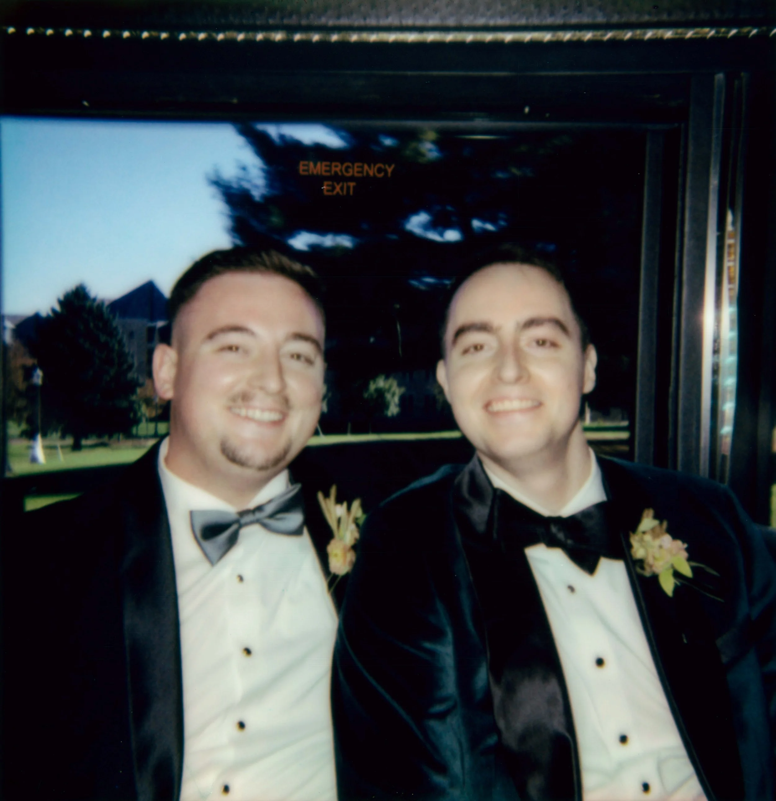 LBW40-groom-groomsman-smiling-on-limo.jpg