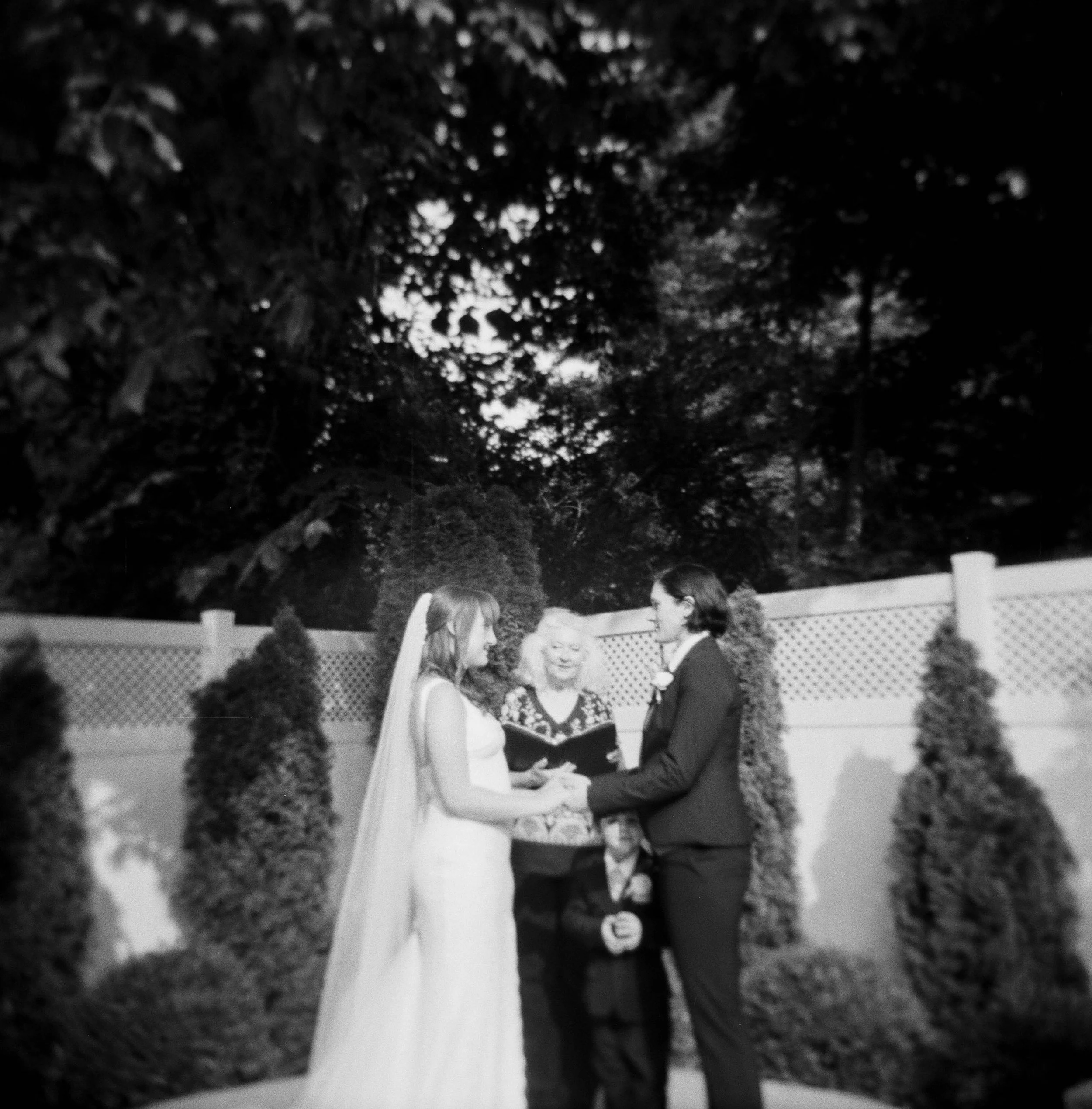 lgbtq-wedding-ceremony-holga-brides-with-officiant.jpg