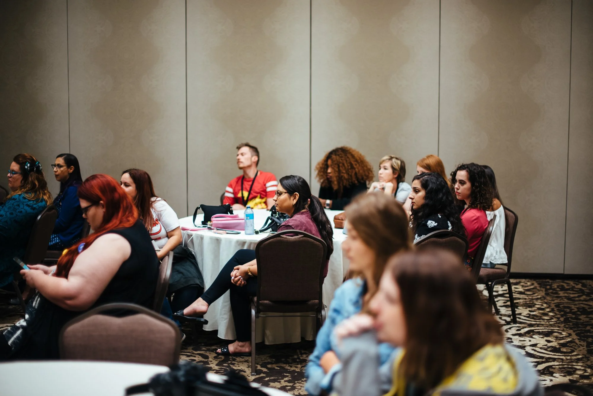 BT132-crowd-listening-to-panel-at-table.jpg