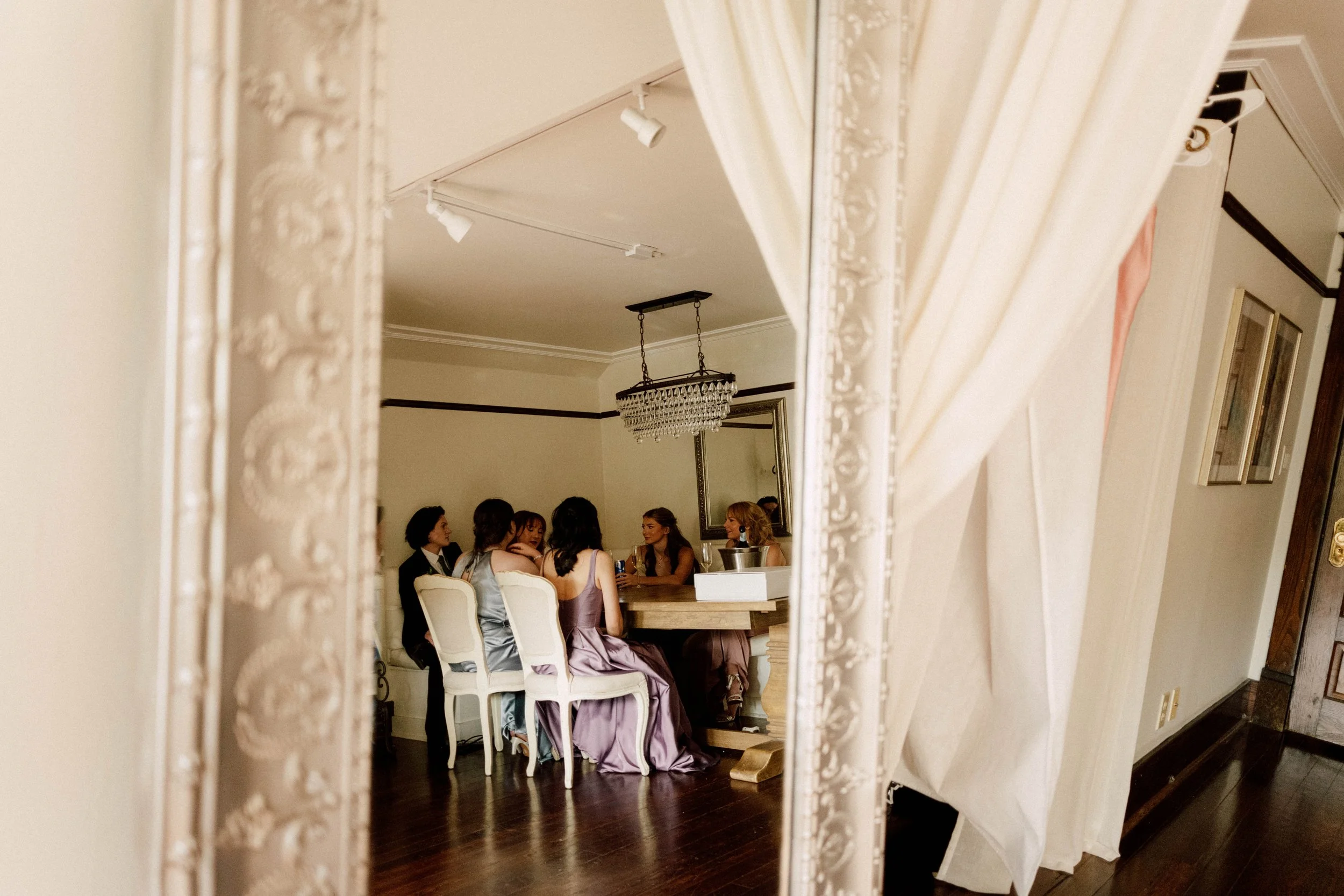 HRD19-bridesmaids-sitting-at-table-in-mirror.jpg