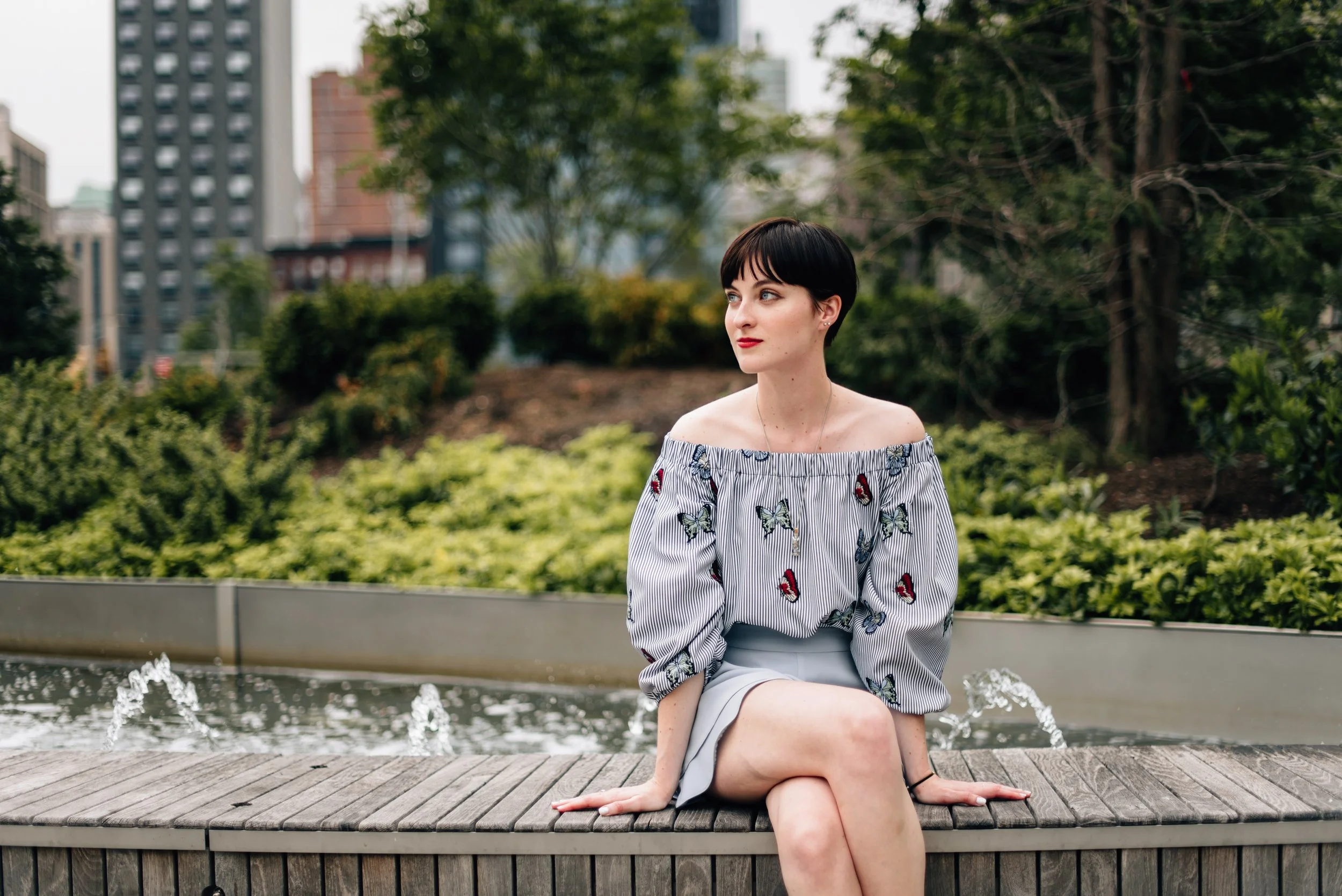 BT62-woman-pixiecut-sitting-by-fountain.jpg