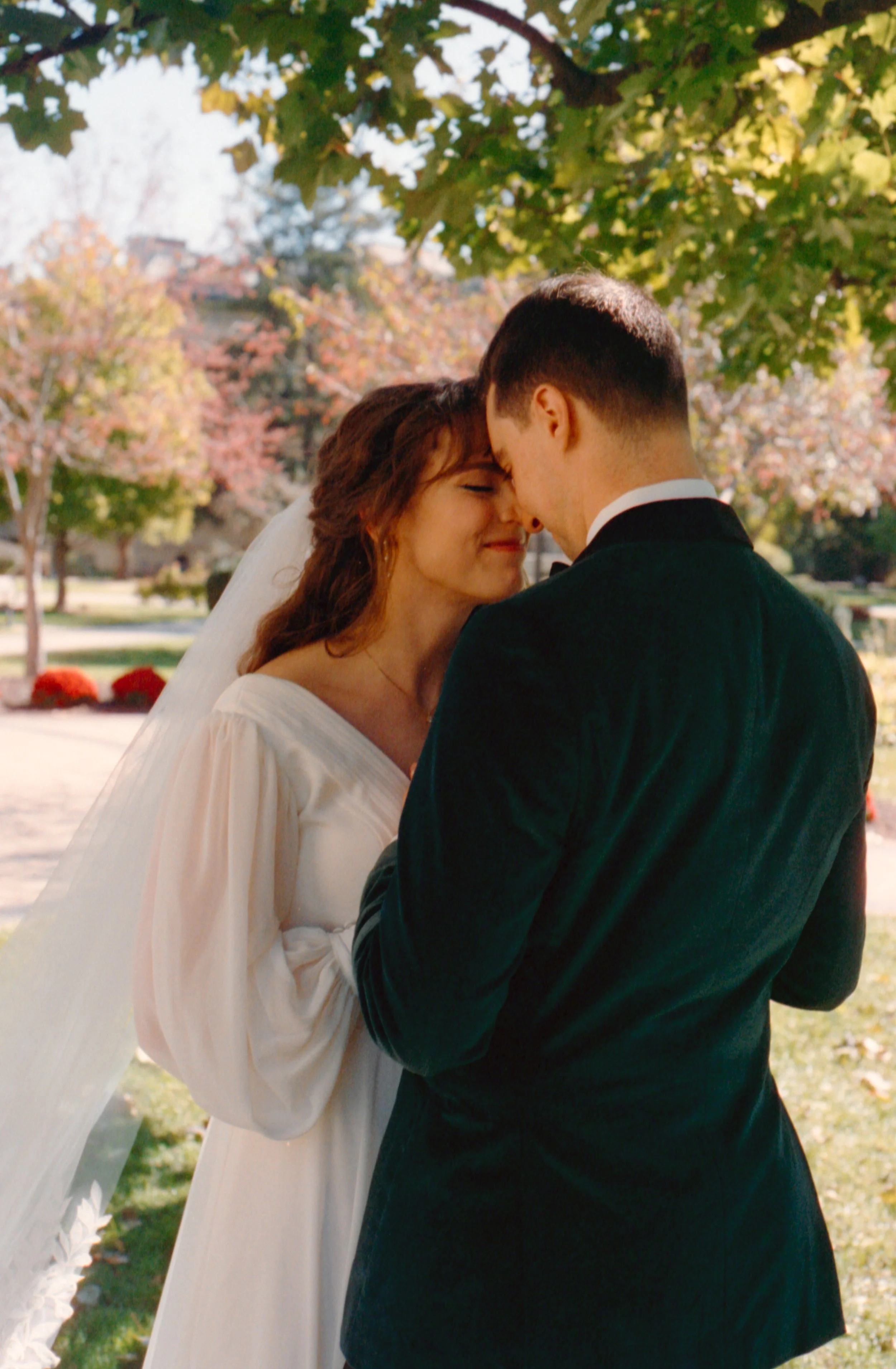LBW15-bride-groom-foreheads-together-smiling-under-tree.jpg
