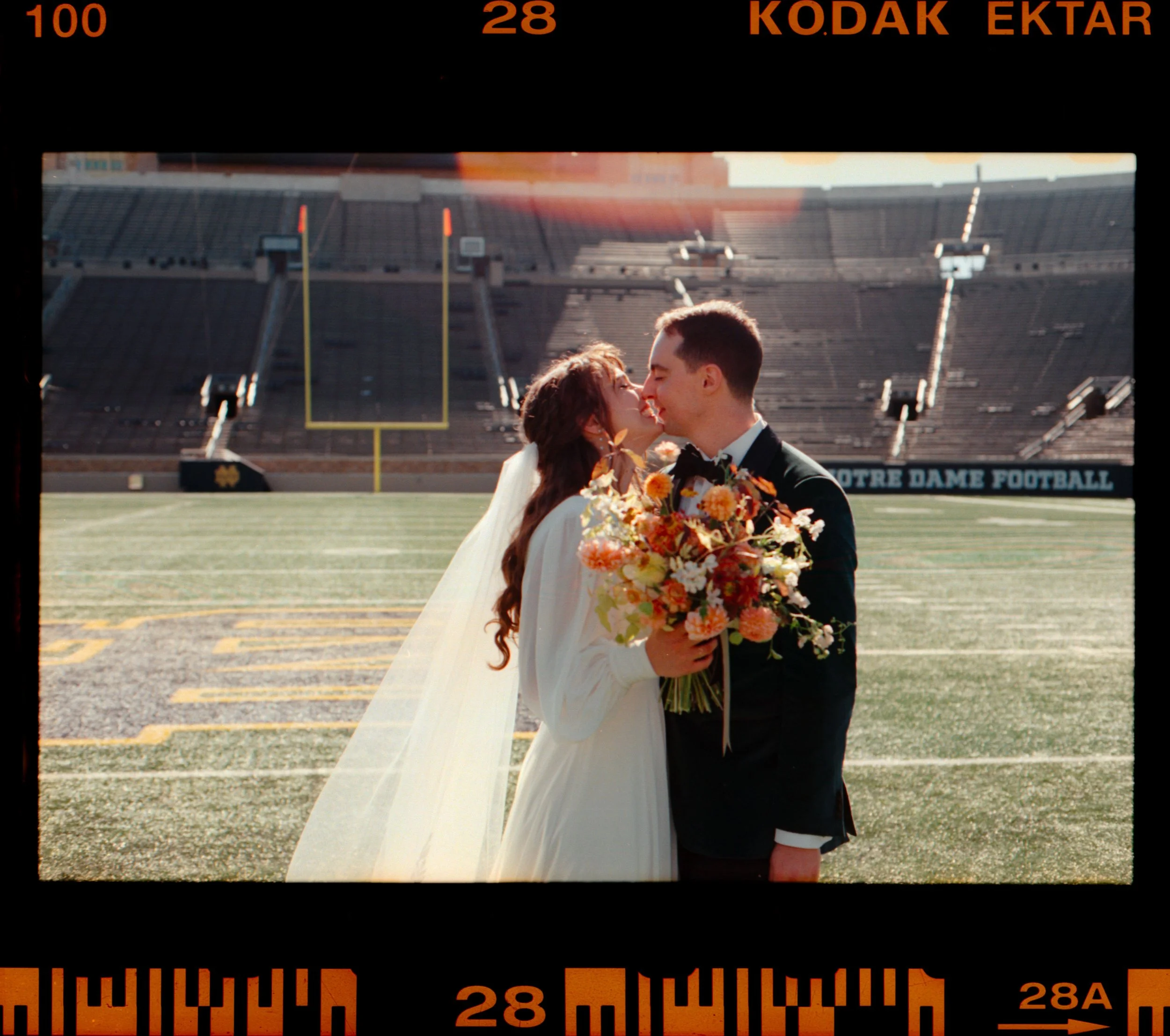 LBW50-bride-groom-kiss-notre-dame-football-stadium-ektar-film.jpg
