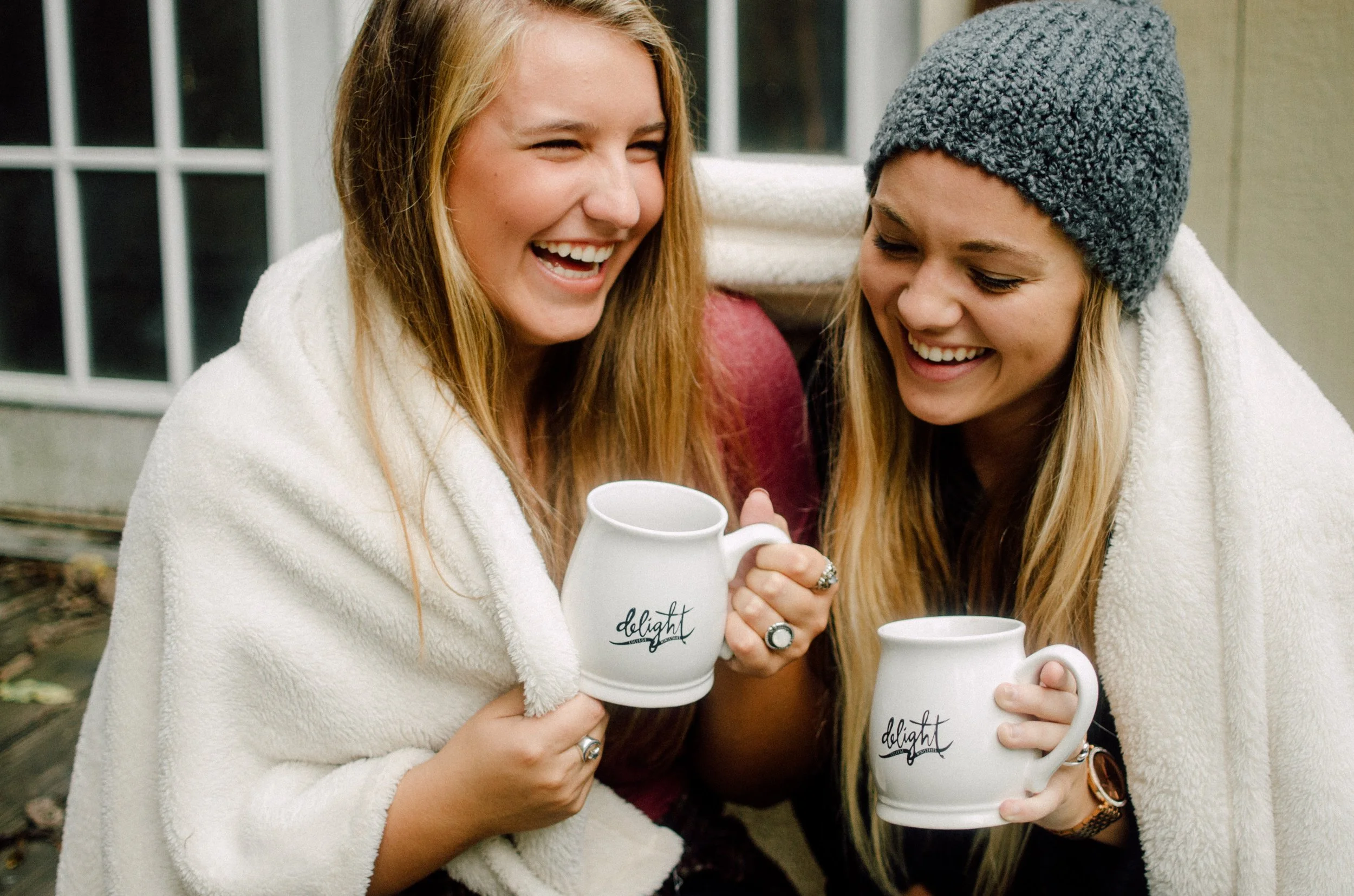 d109-women-under-blanket-with-mugs.jpg