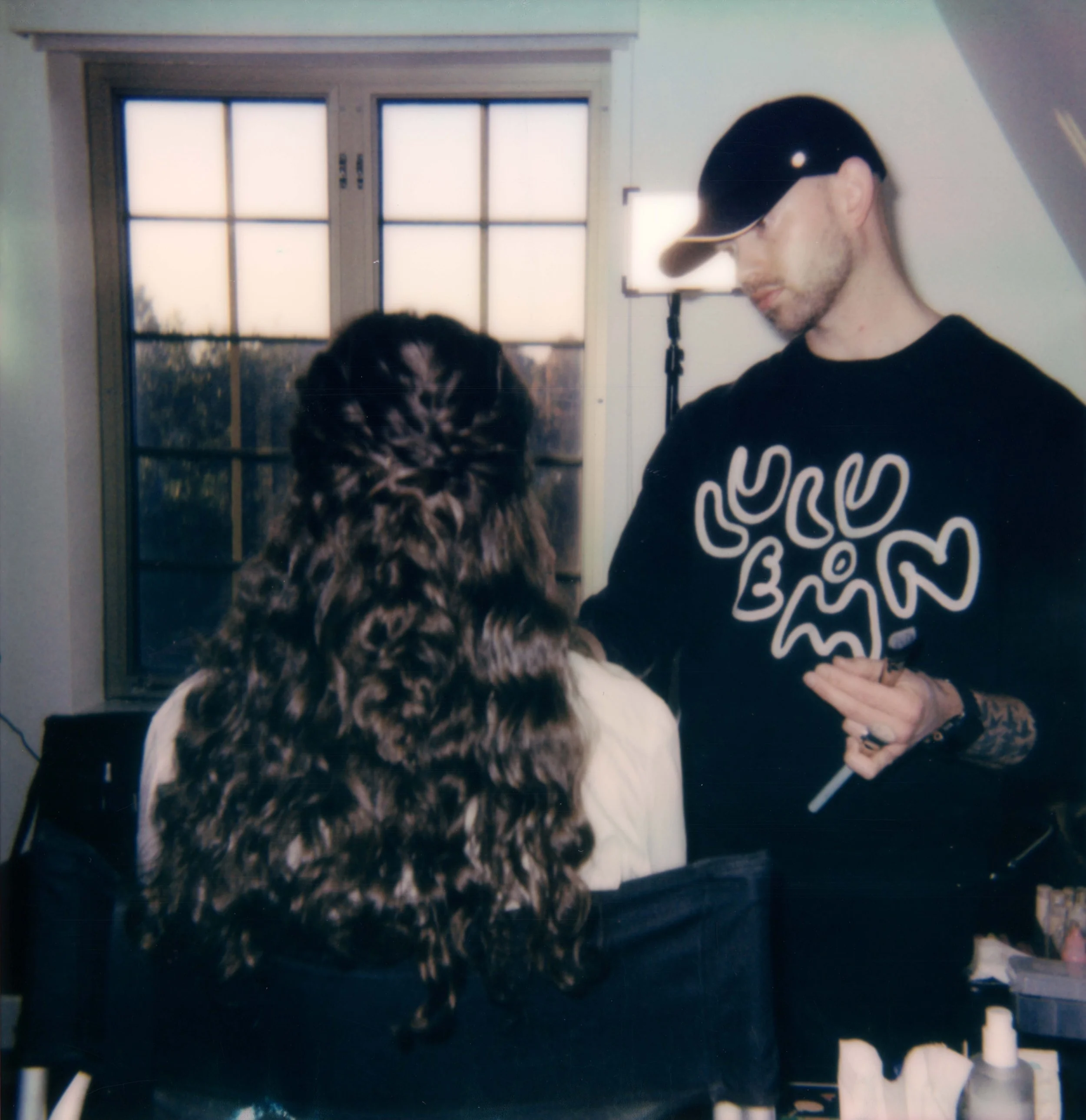 LBW3-polaroid-man-in-ball-cap-doing-makeup.jpg