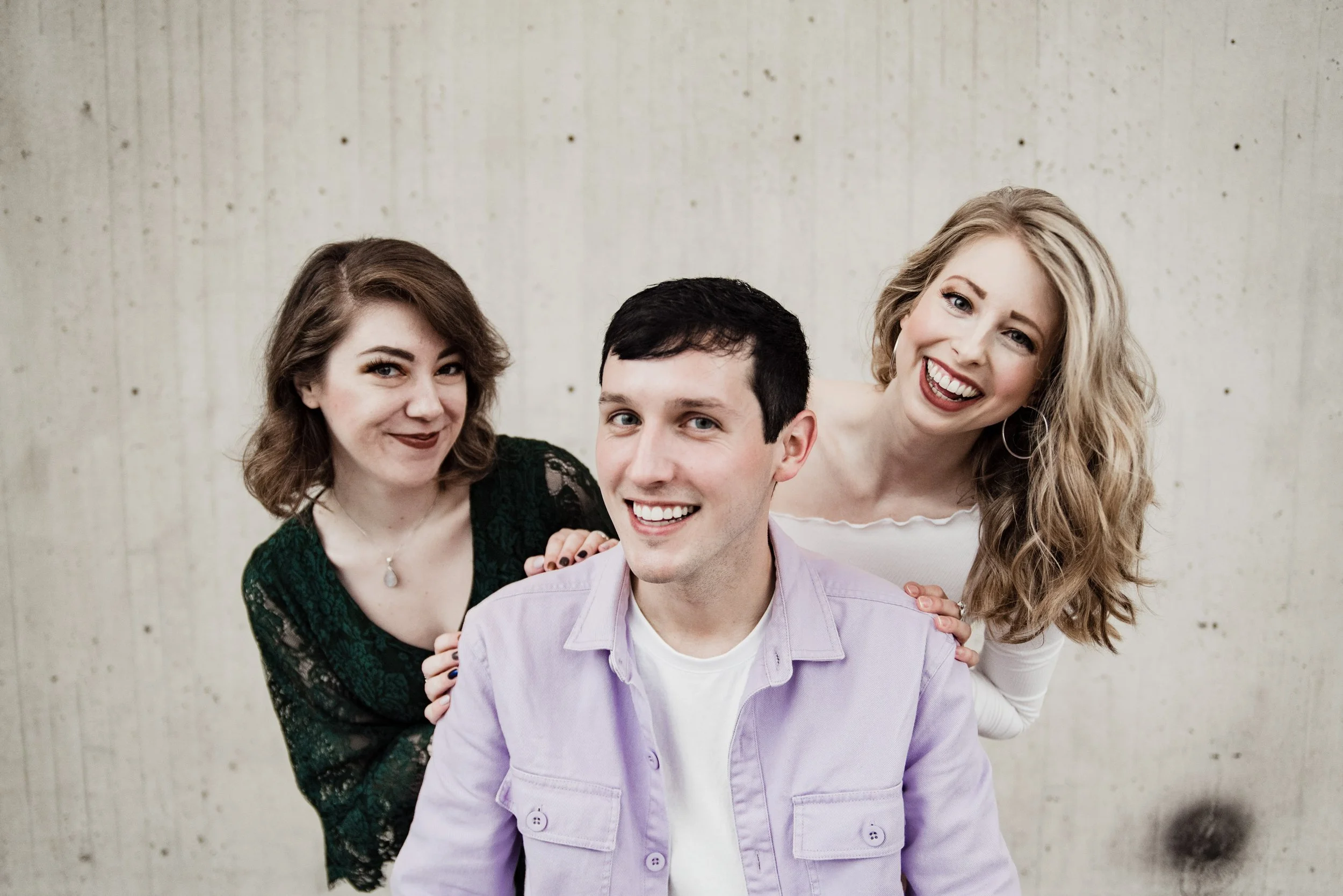 BT291-three-people-smiling-concrete-background.jpg