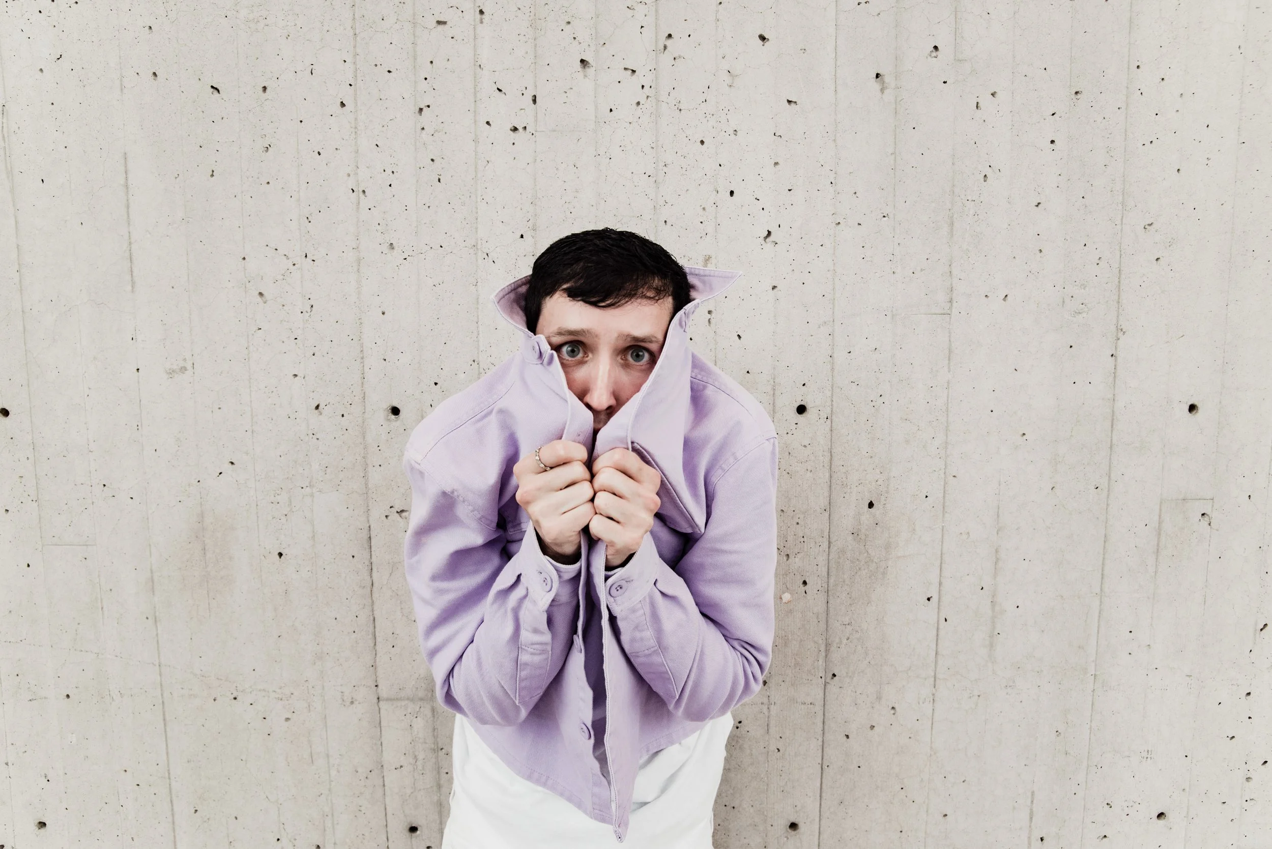 BT278-man-hiding-in-purple-jacket-scared.jpg
