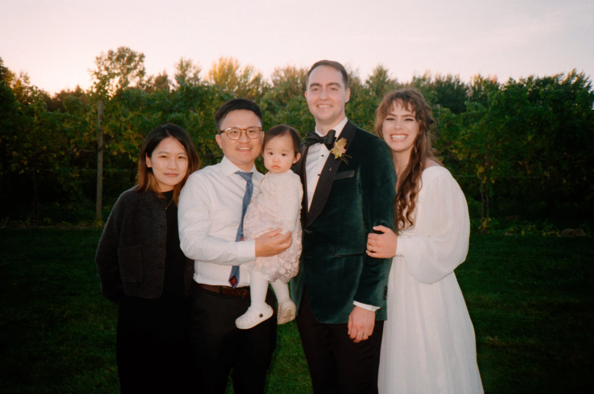 LBW116-bride-groom-with-guests-smiling.jpg