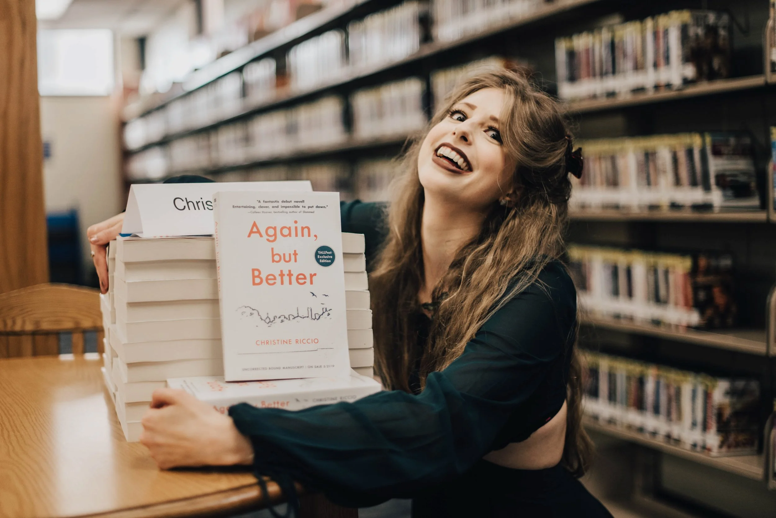 BT156-christine-riccio-with-arcs-again-but-better-books-goofy-face.jpg