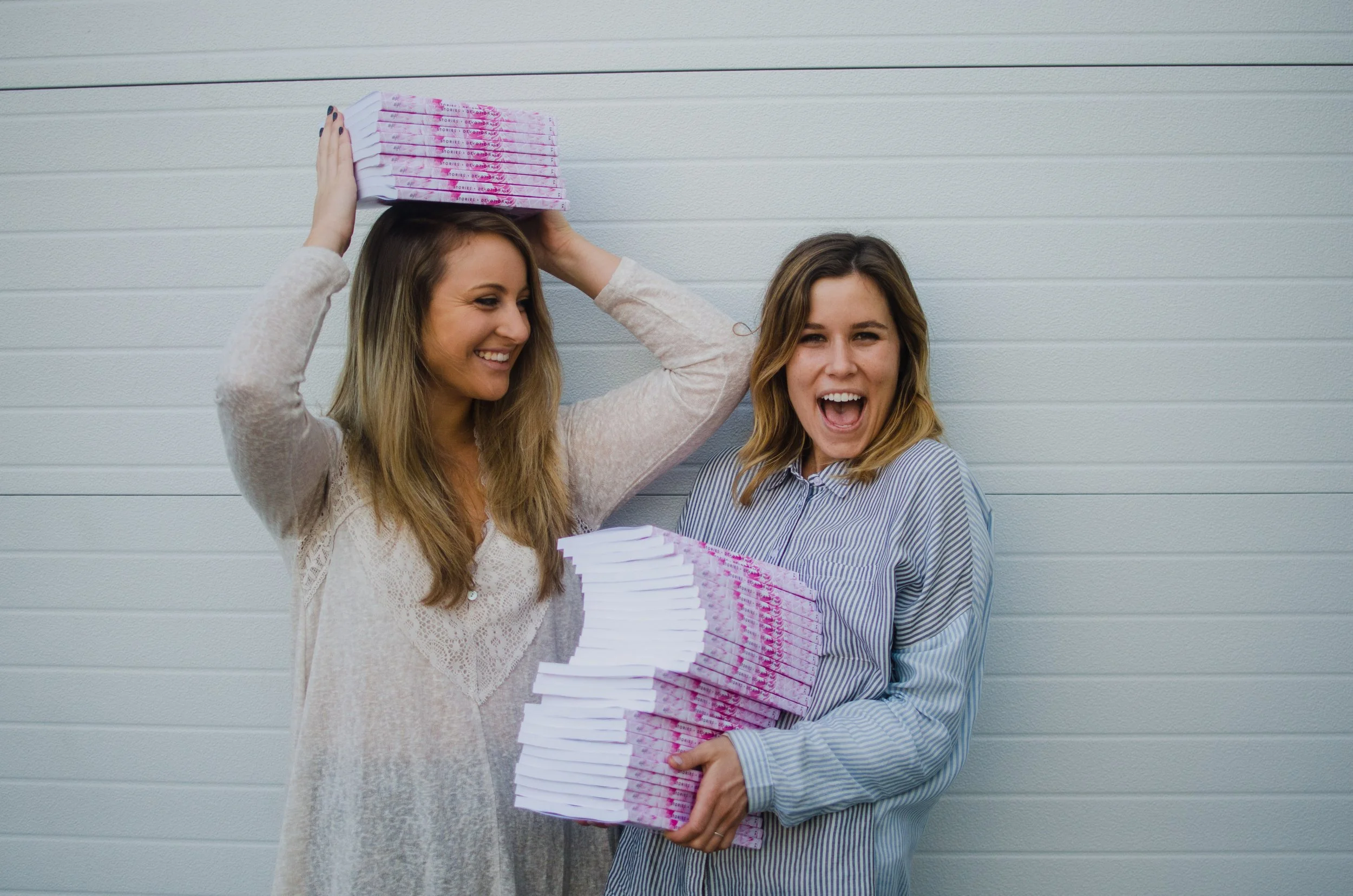 d137-women-holding-book-stacks.jpg