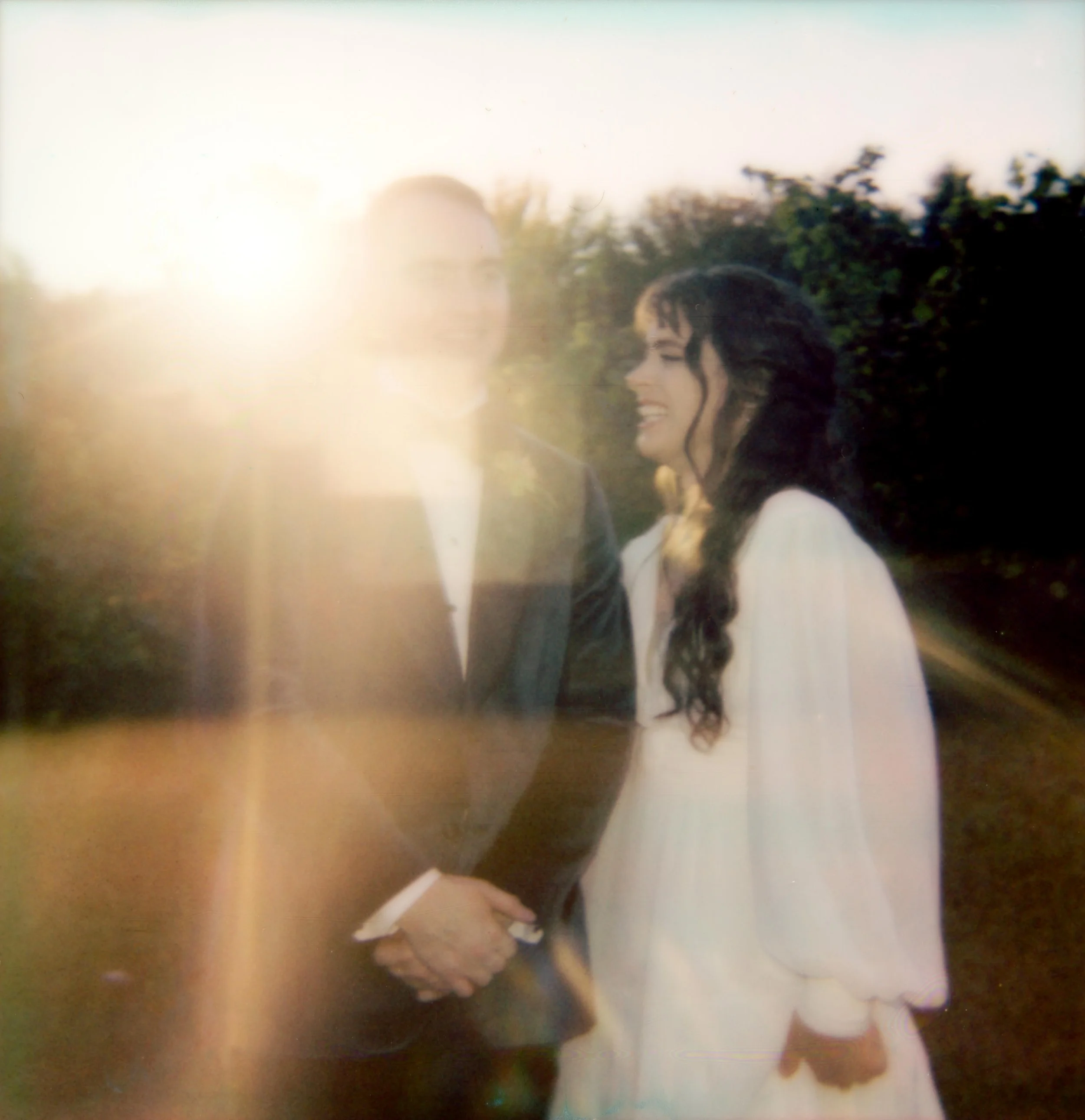 LBW96-wedding-couple-laughing-at-sunset-polaroid.jpg