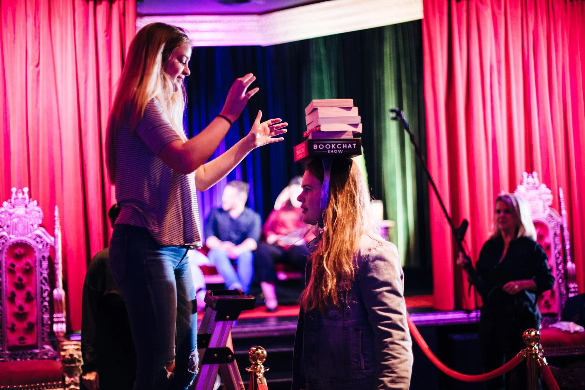 BT187-woman-balancing-books-on-head-dramatic-lighting.jpg
