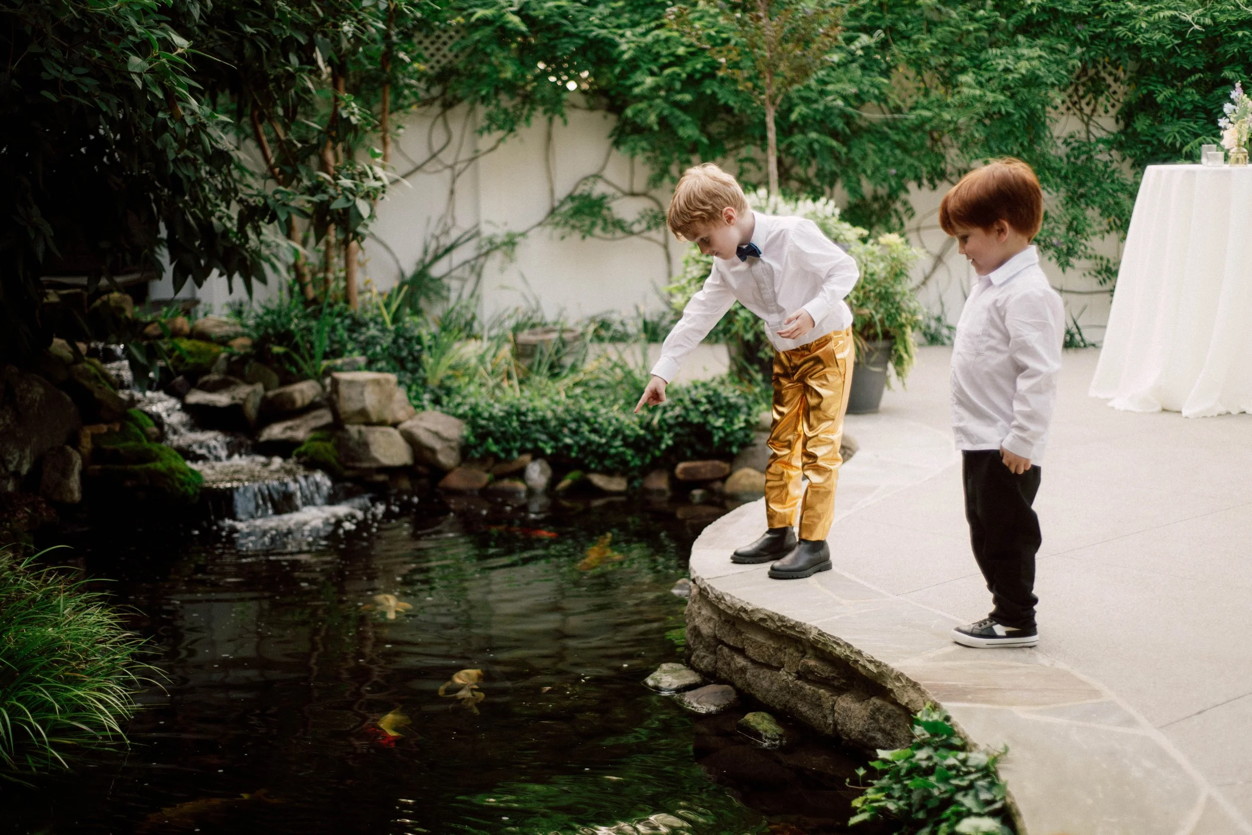 HRD53-boys-playing-by-koi-pond-at-wedding.jpg
