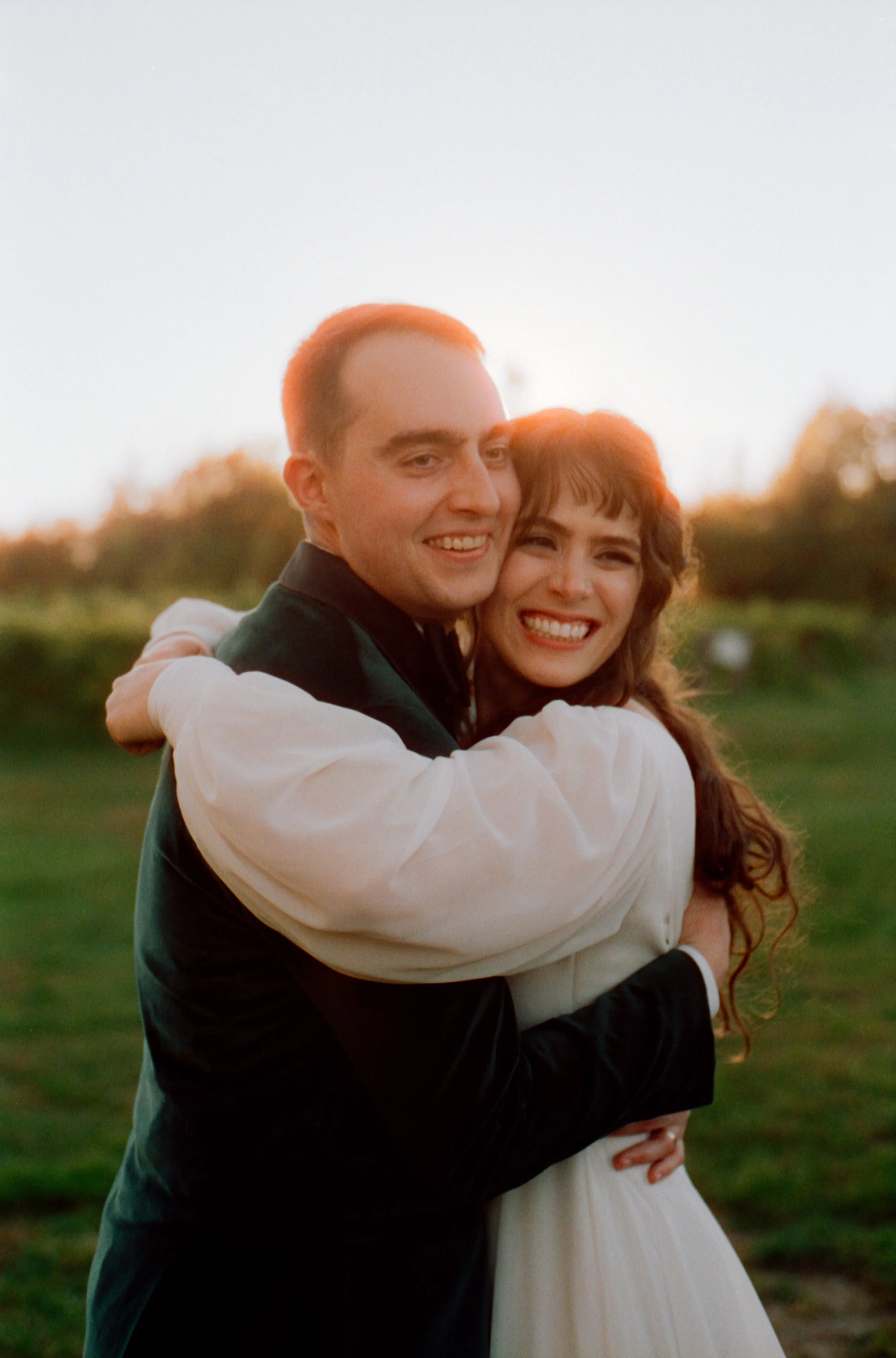 LBW112-wedding-couple-hugging-smiling-sunset.jpg