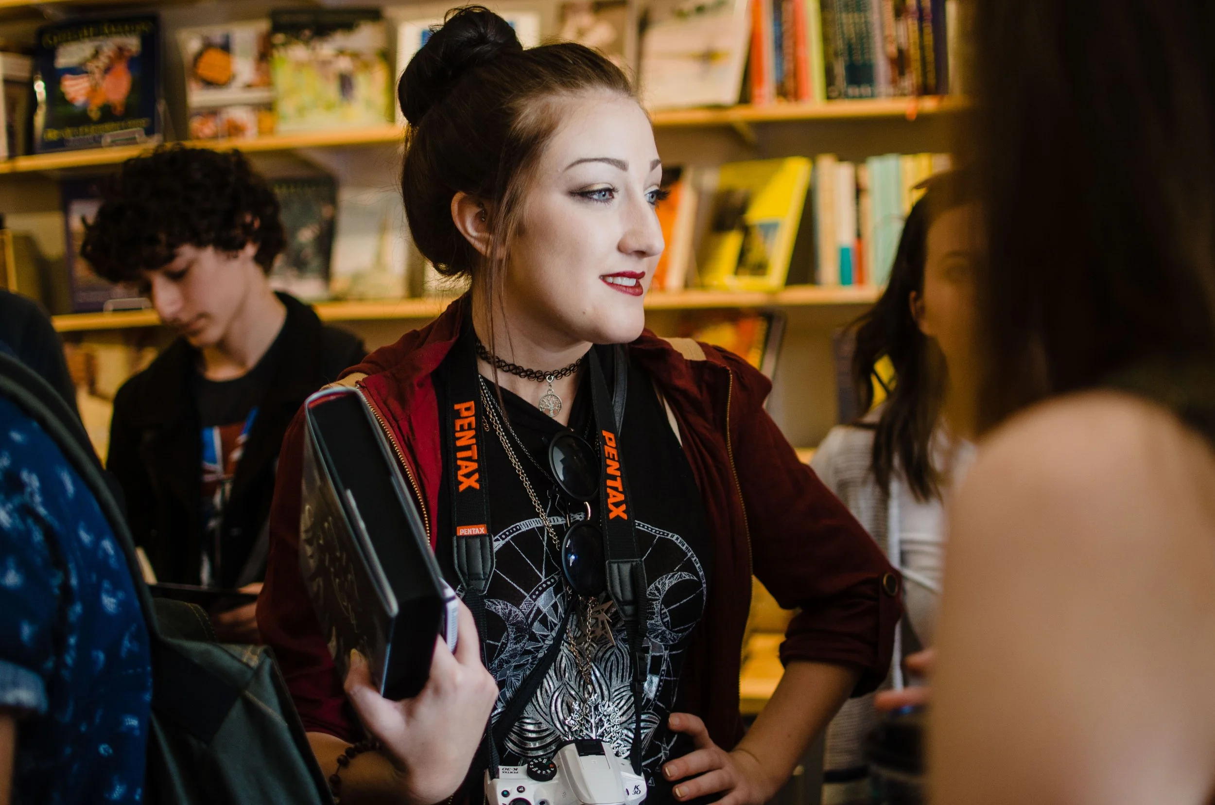BT6-woman-with-pentax-camera-strap-holding-book.jpg