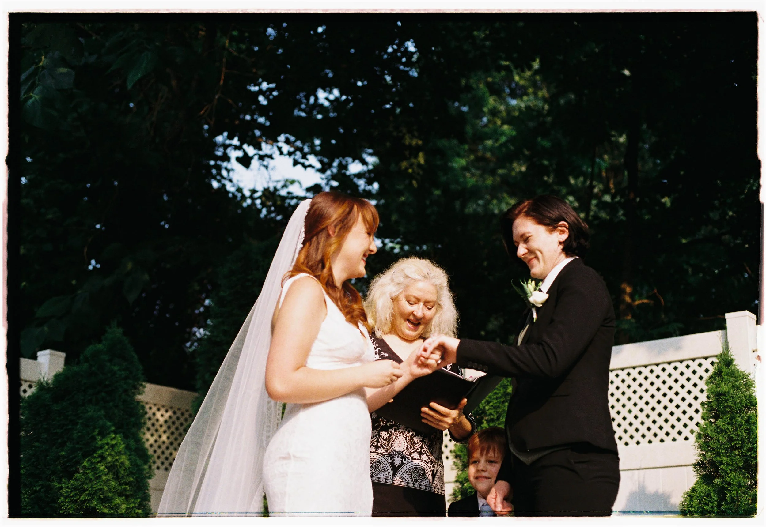 HRB4-brides-standing-with-officiant-at-wedding-ceremony.jpg