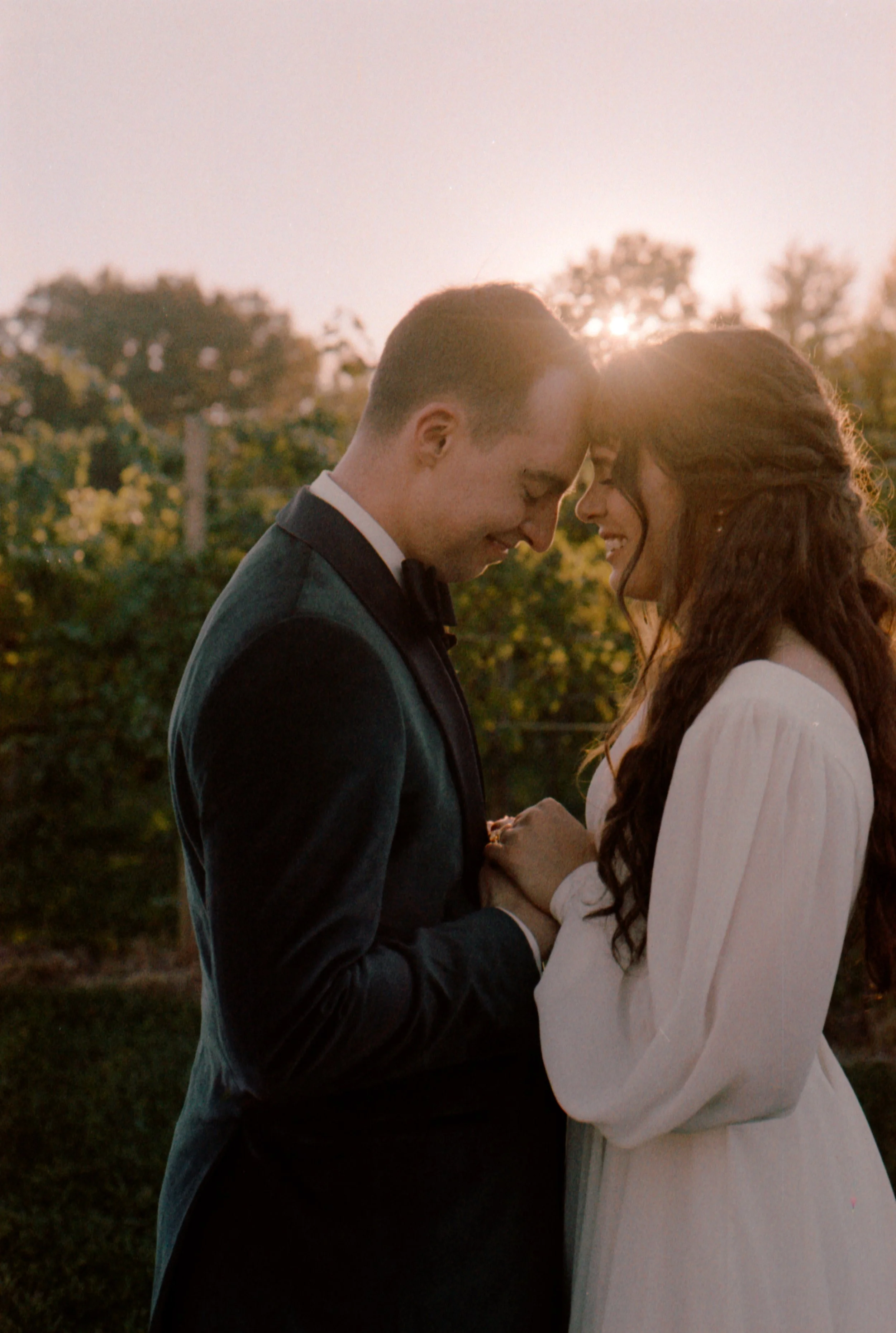 LBW99-bride-groom-holding-hands-foreheads-together.jpg