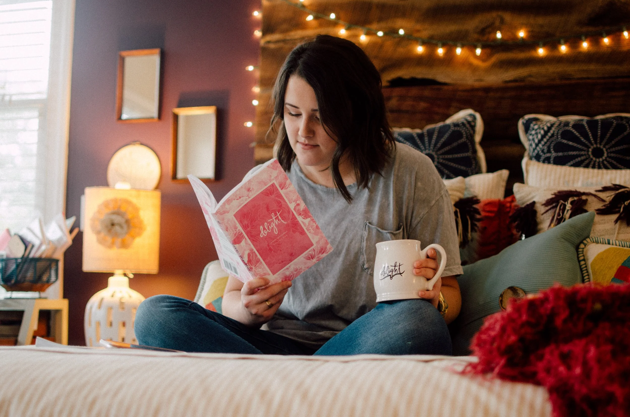 d178-woman-reading-book-holding-mug-delight.jpg