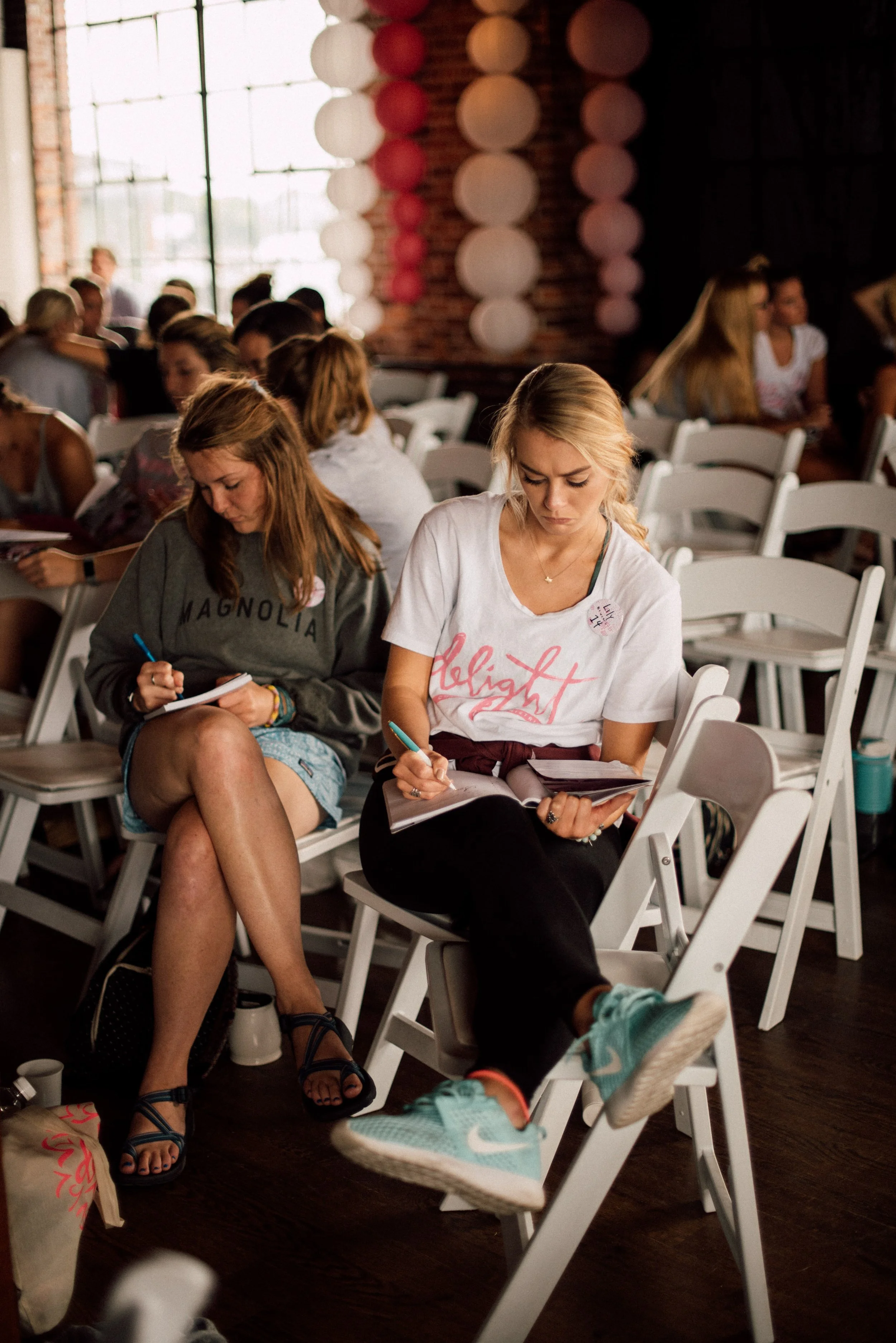 d244-women-writing-at-conference.jpg