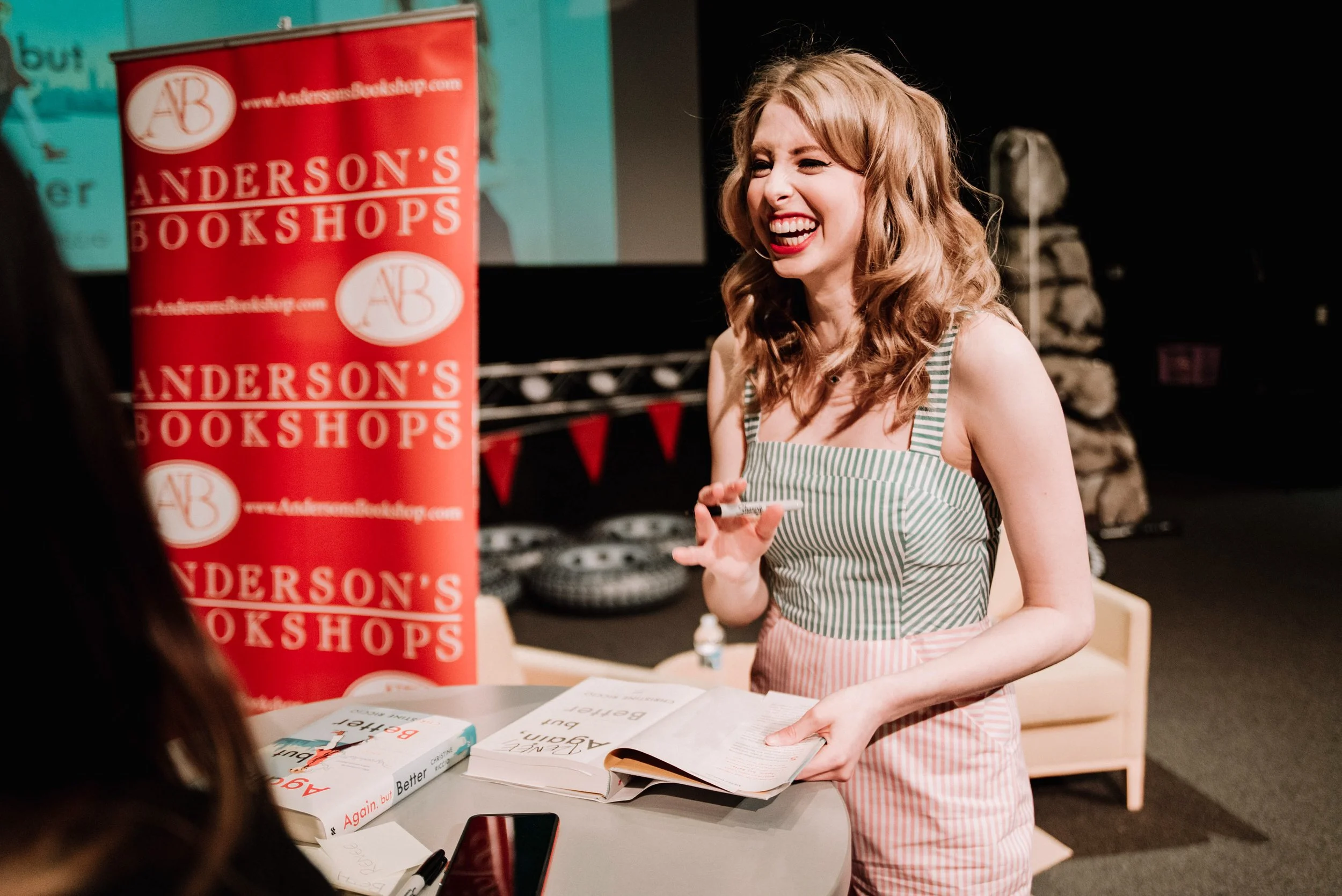 BT237-woman-laughing-at-book-signing.jpg