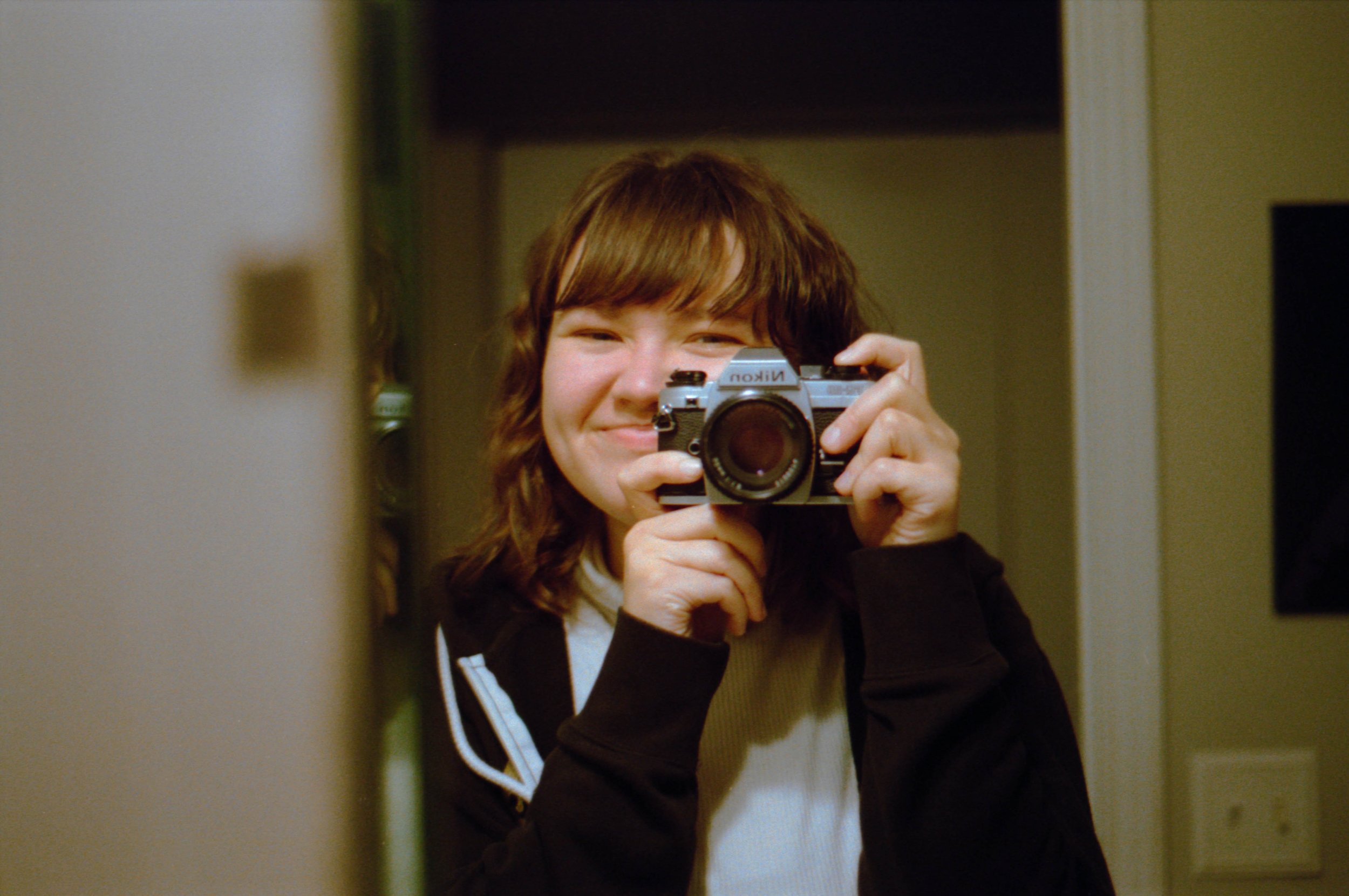 week-47-woman-smiling-in-mirror-with-camera.jpg