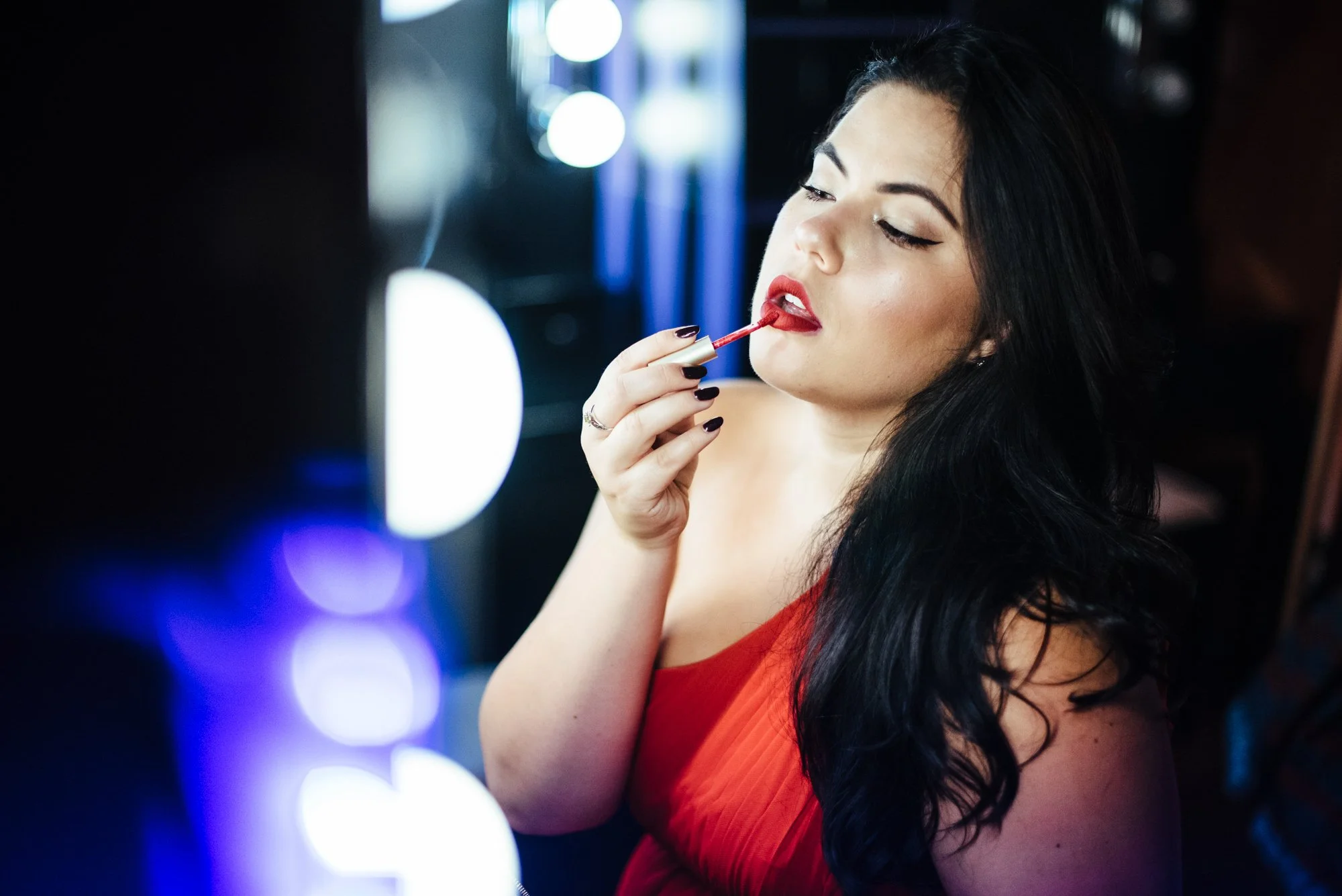BT210-woman-putting-on-red-lipstick.jpg
