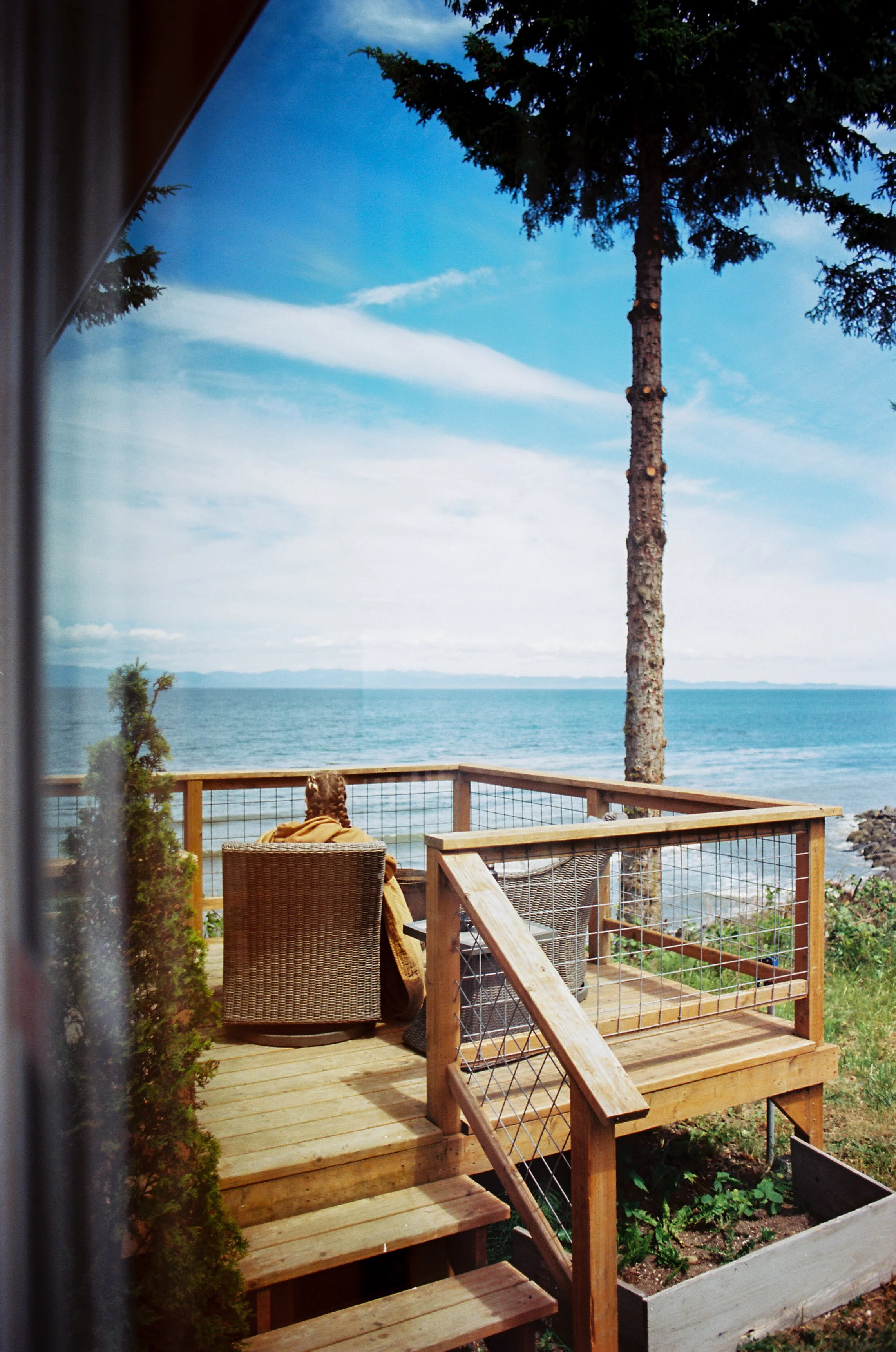 pnw146-woman-sitting-on-porch-through-window.jpg