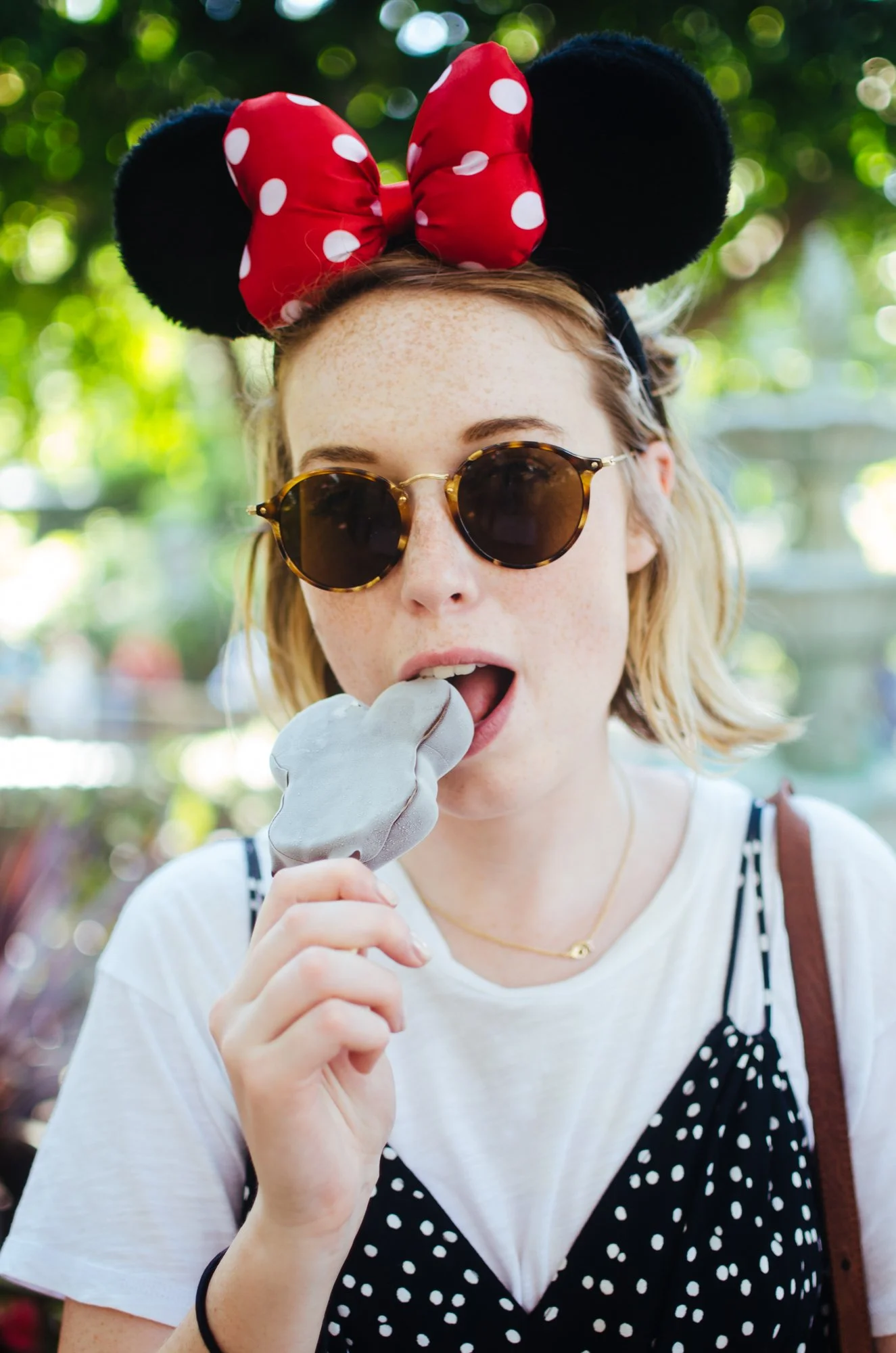 BT65-woman-in-sunglasses-mickey-mouse-hat-eating-ice-cream.jpg