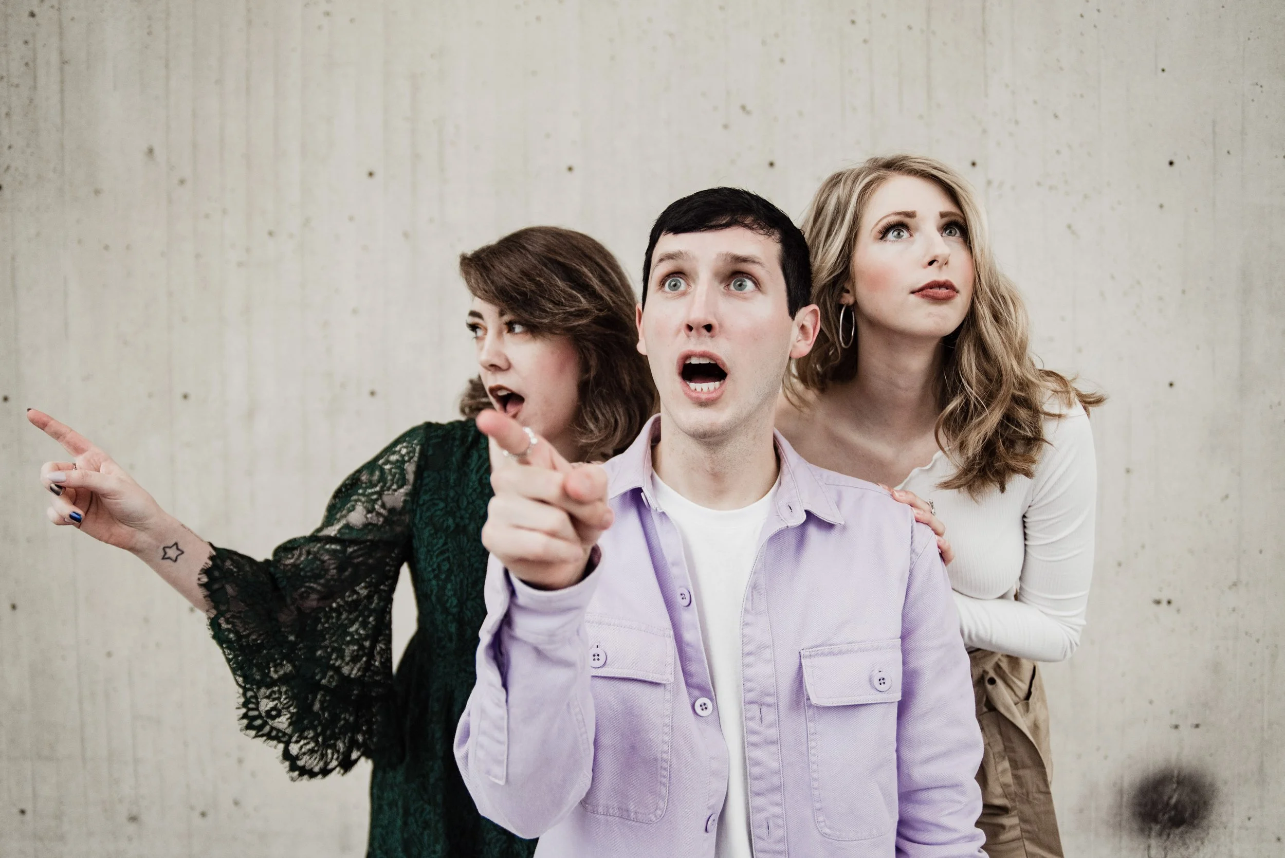 BT292-three-people-pointing-concrete-background.jpg