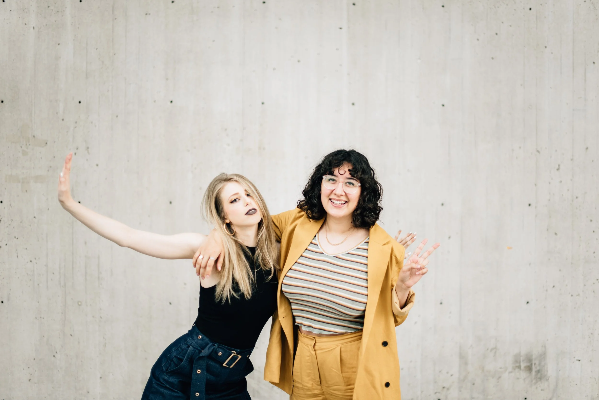 BT78-two-women-concrete-wall-smiling.jpg