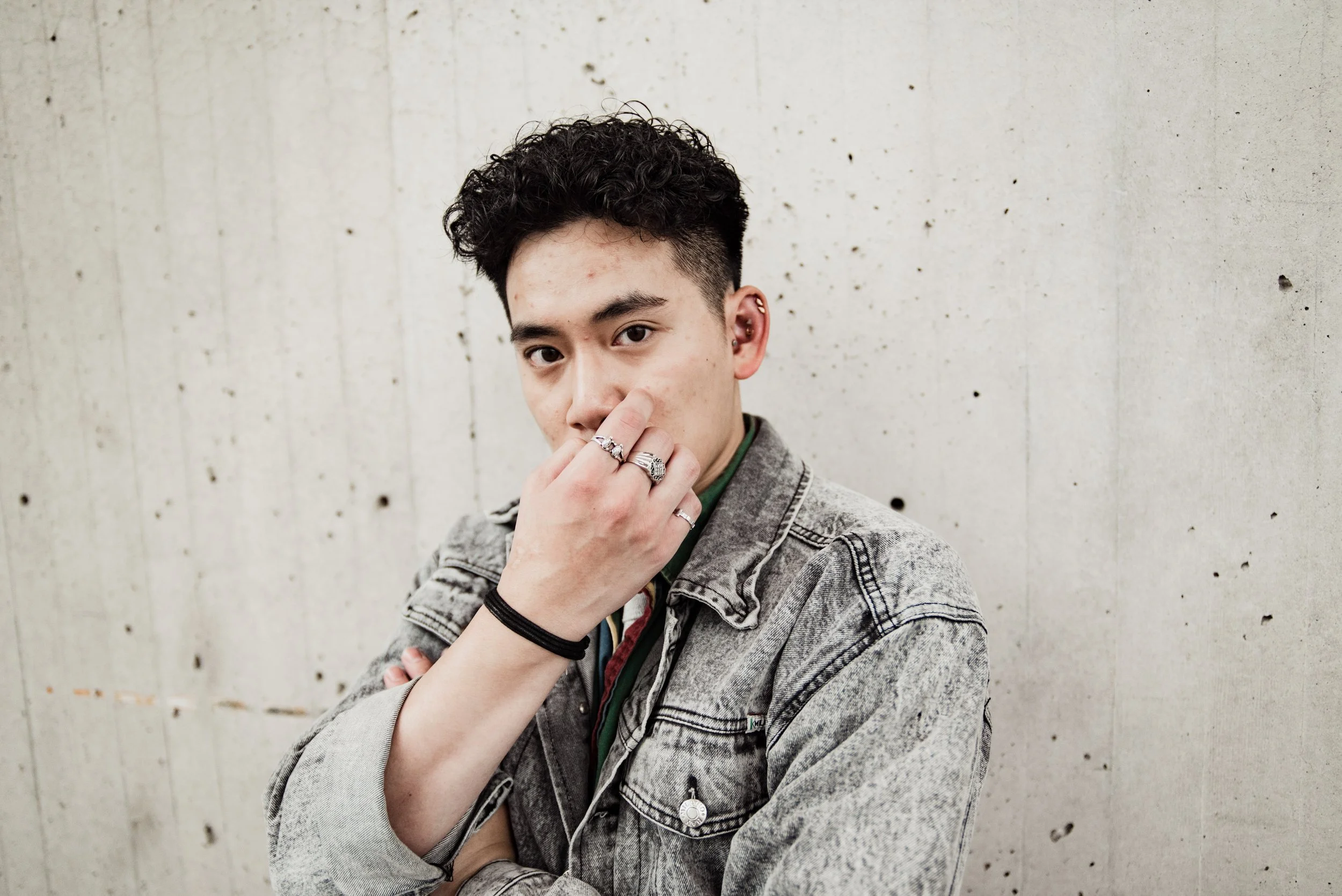 BT303-asian-man-jean-jacket-hand-covering-face.jpg