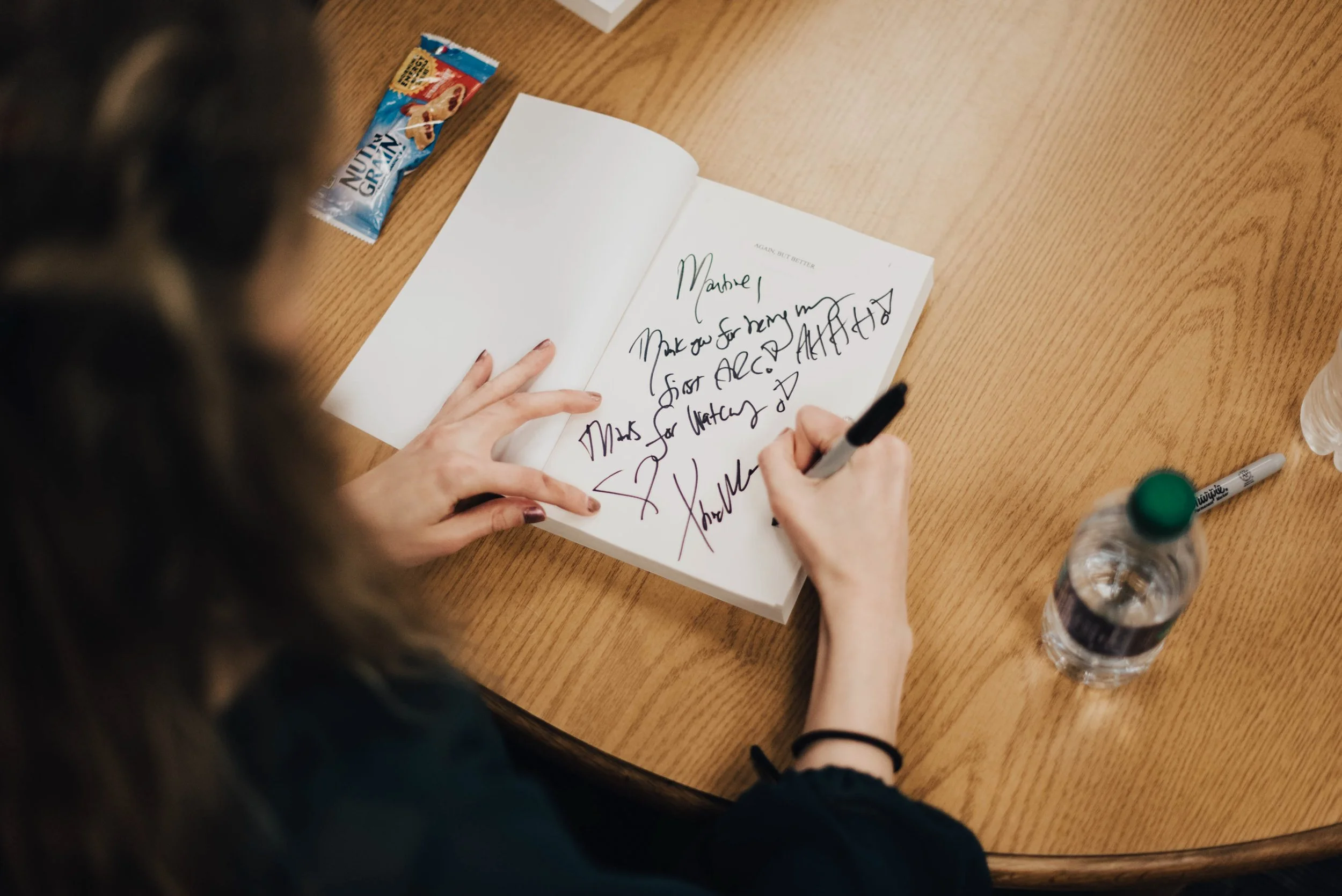 BT162-woman-signing-book.jpg