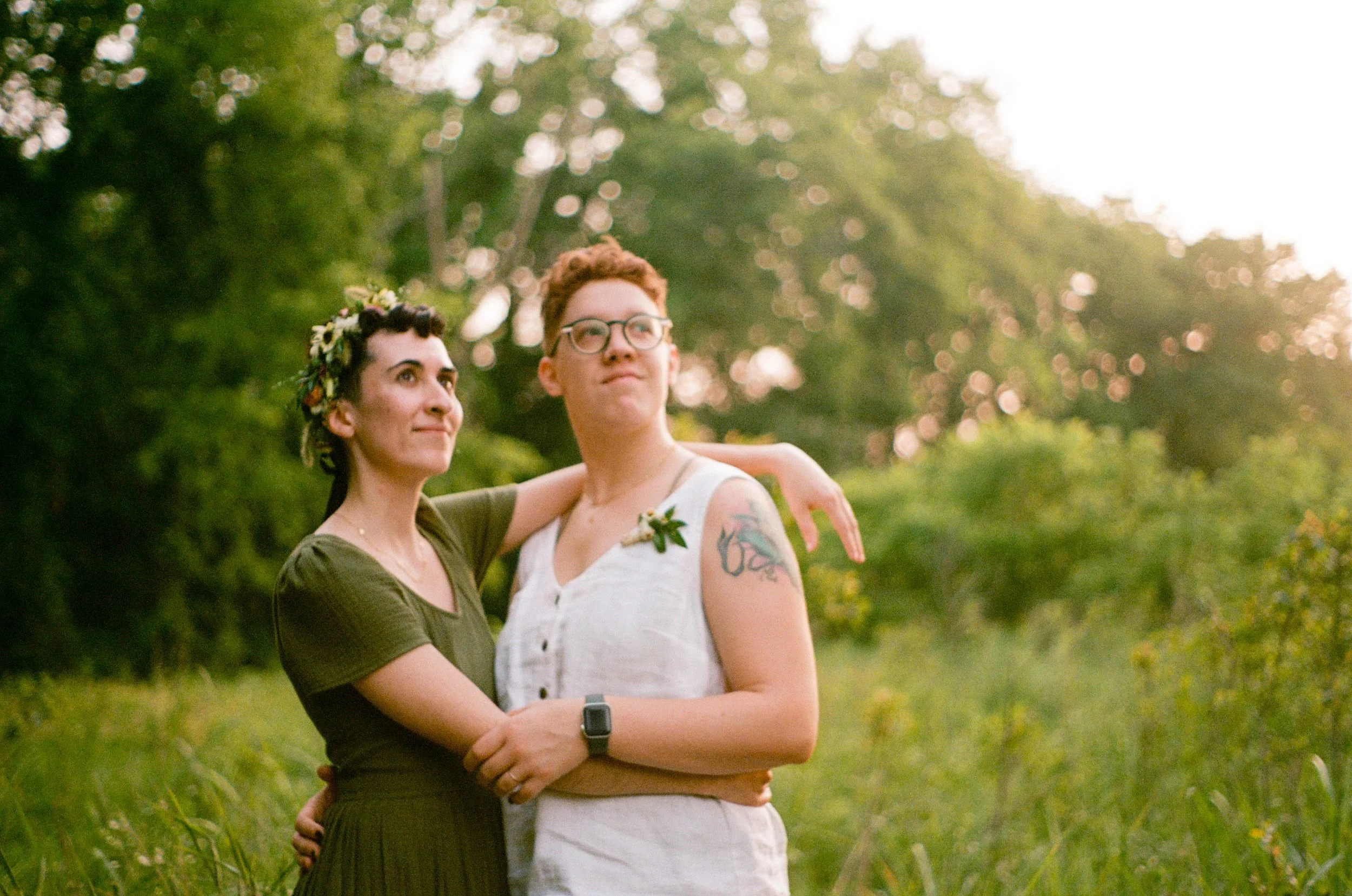 REW90-queer-couple-holding-each-other-field.jpg