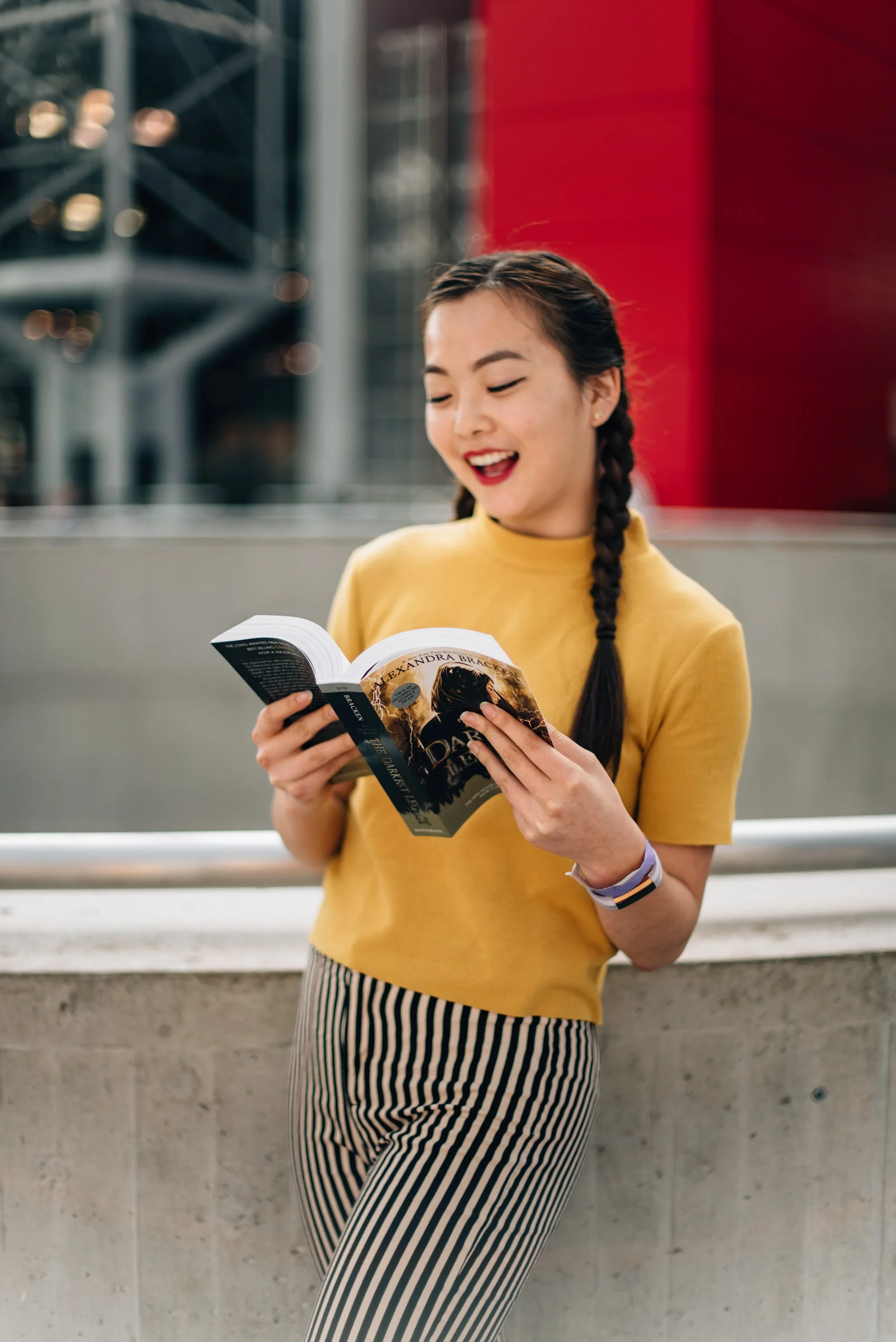 BT136-asian-woman-yellow-top-braid-reading.jpg