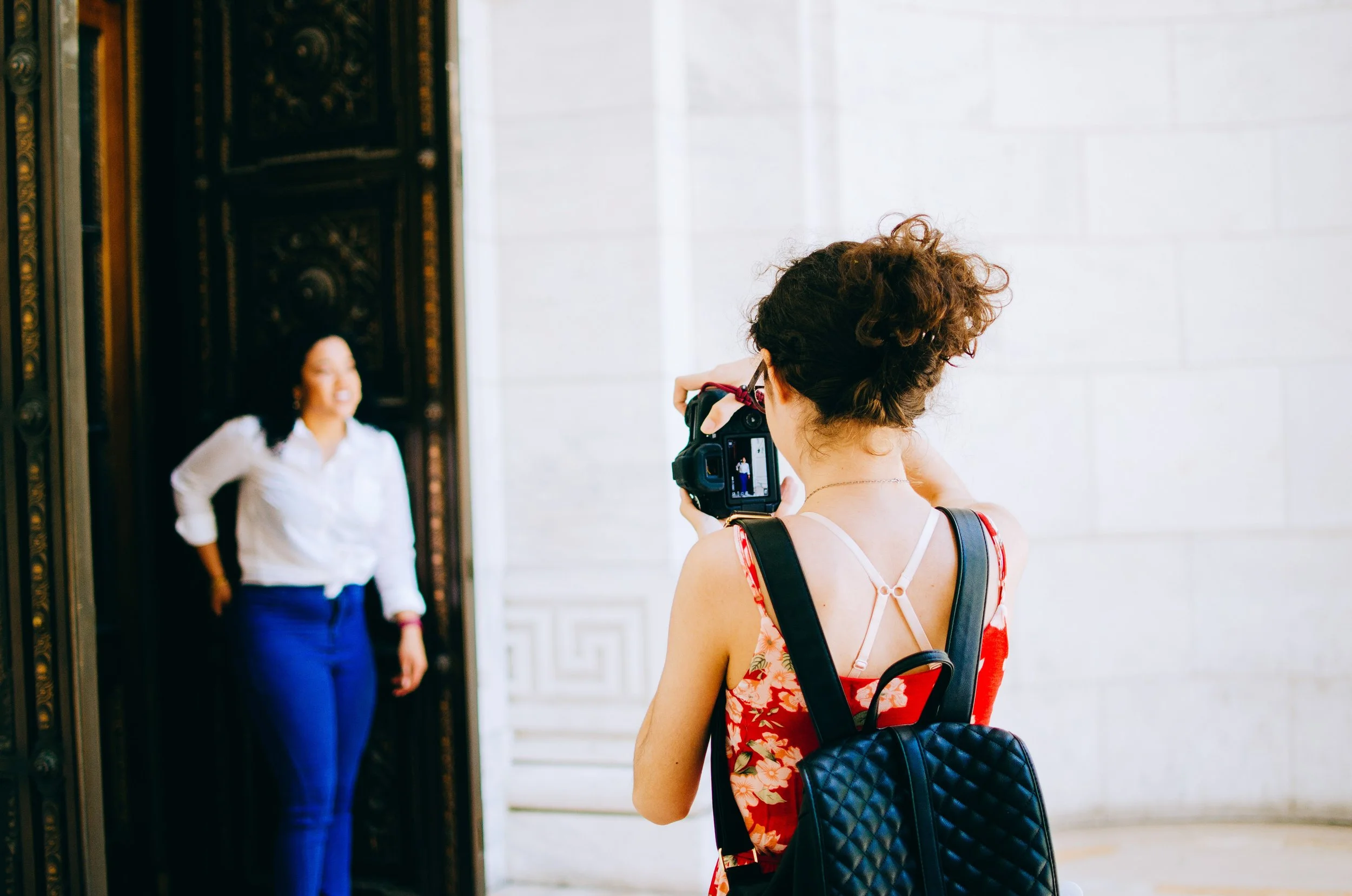 BT168-woman-taking-photo-with-camera.jpg