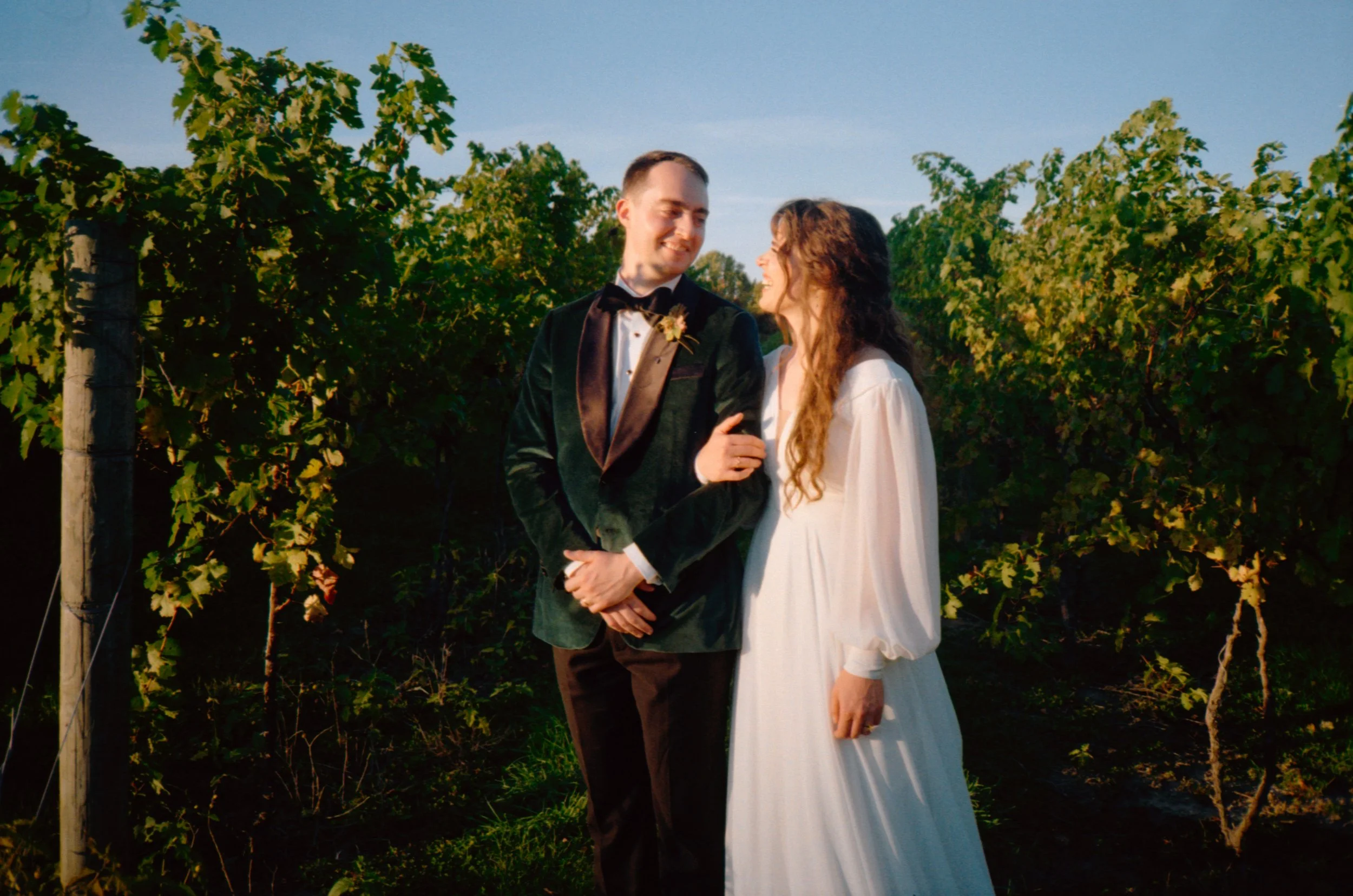 LBW113-bride-groom-smiling-in-vineyard-wedding.jpg