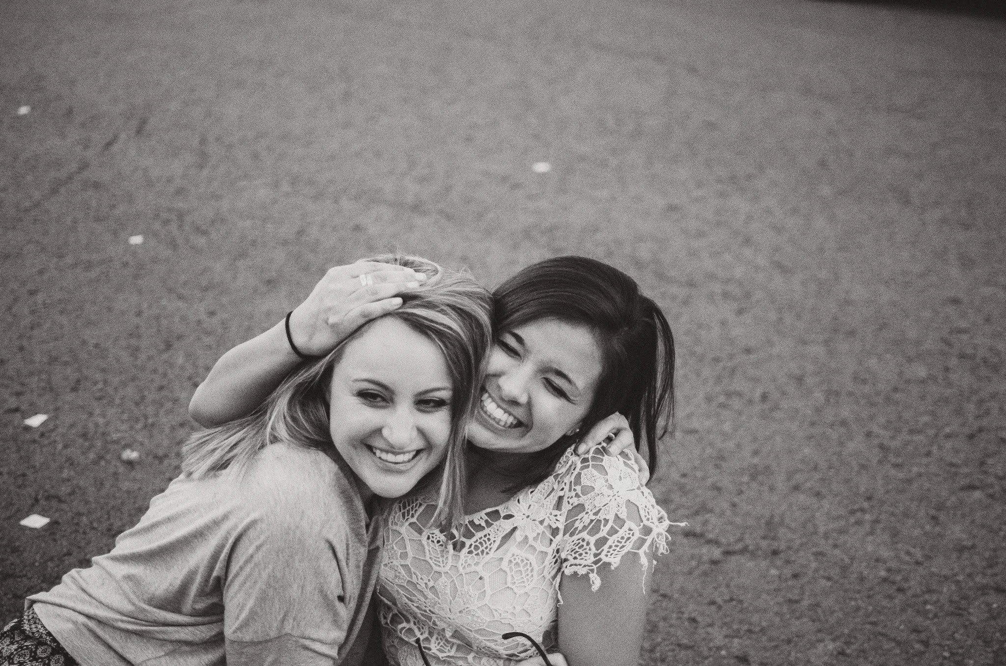 d19-women-hugging-smiling-on-ground.jpg