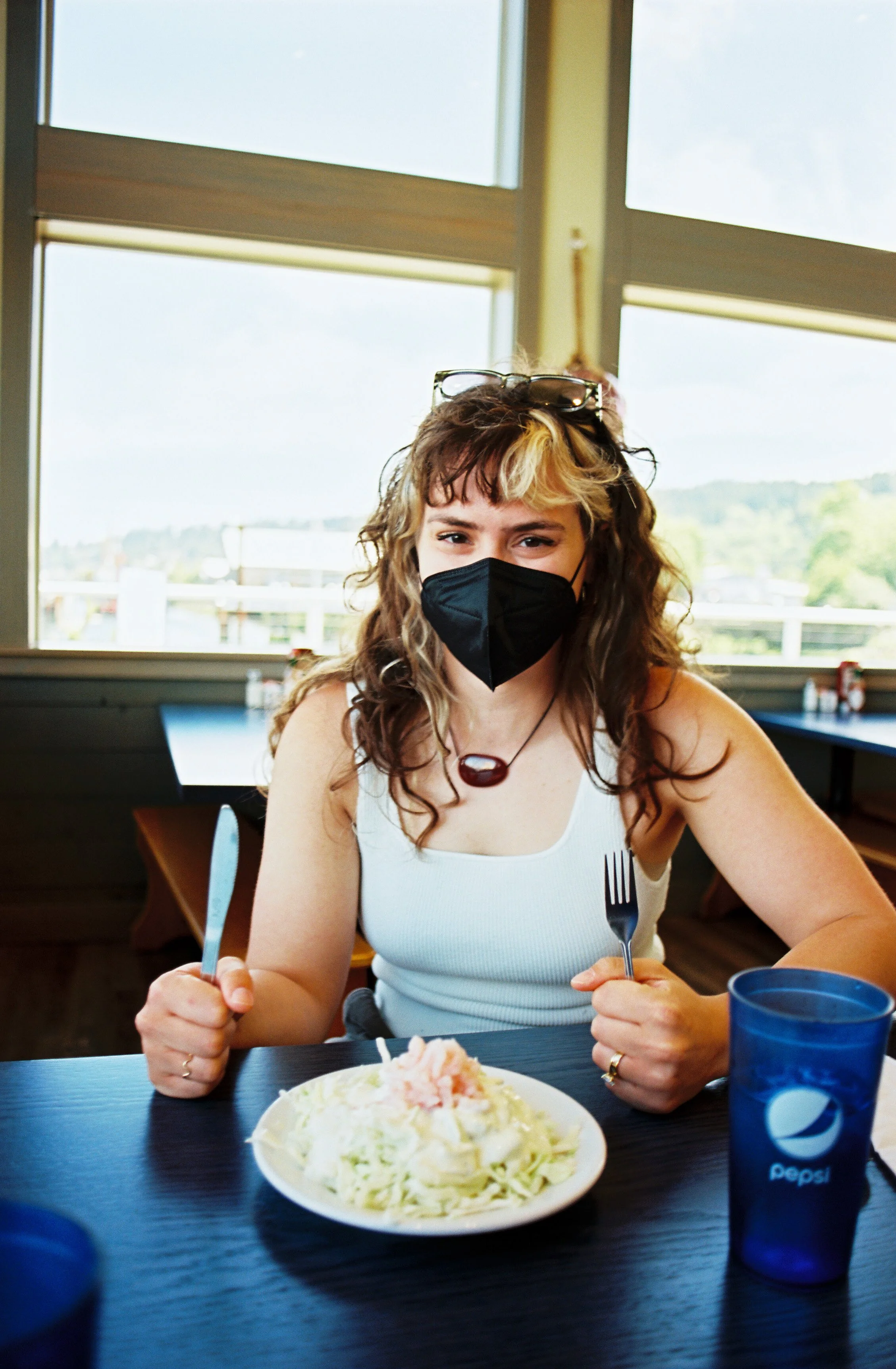 pnw70-woman-eating-coleslaw-in-face-mask-astoria-oregon.jpg
