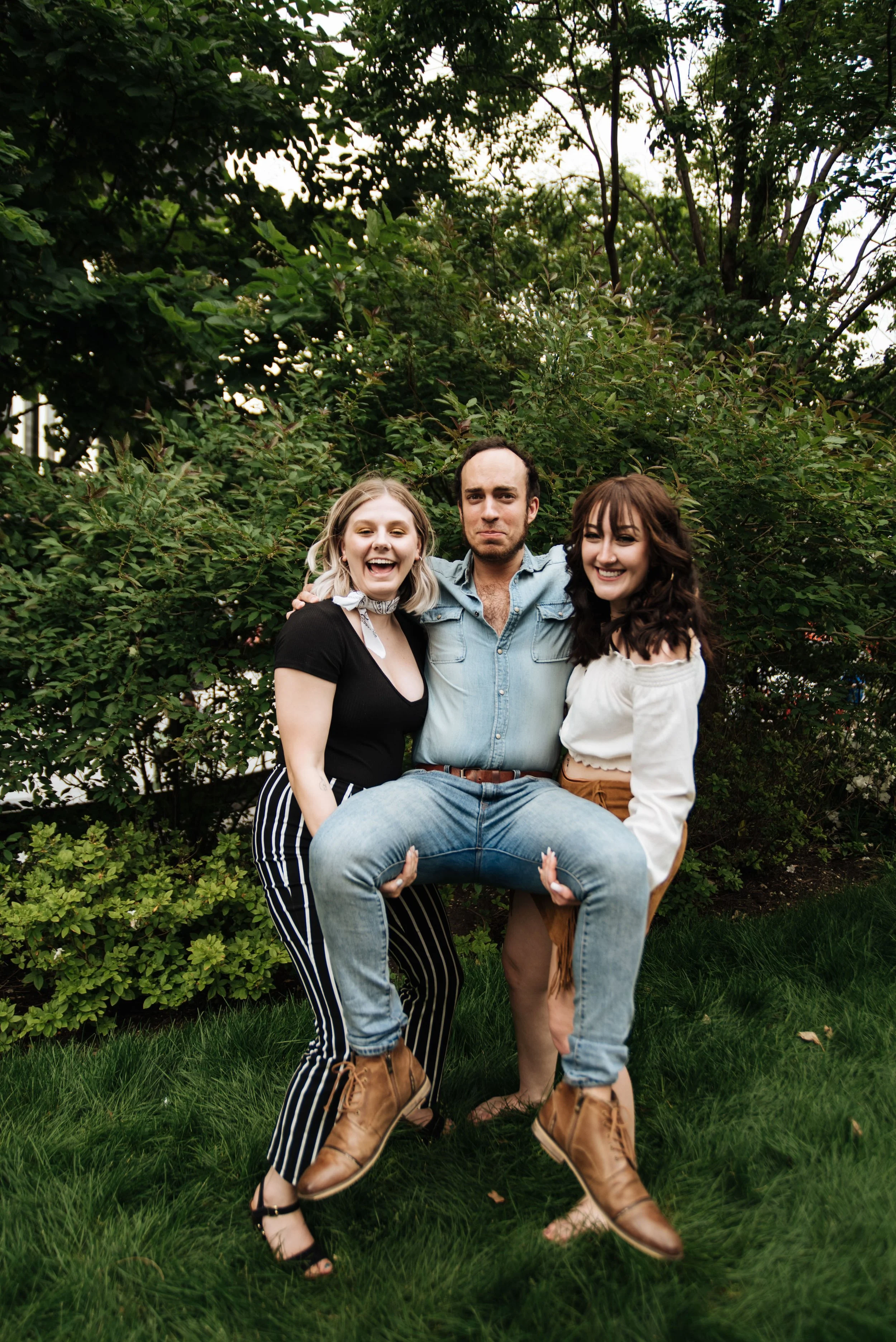 BT371-two-women-holding-man.jpg