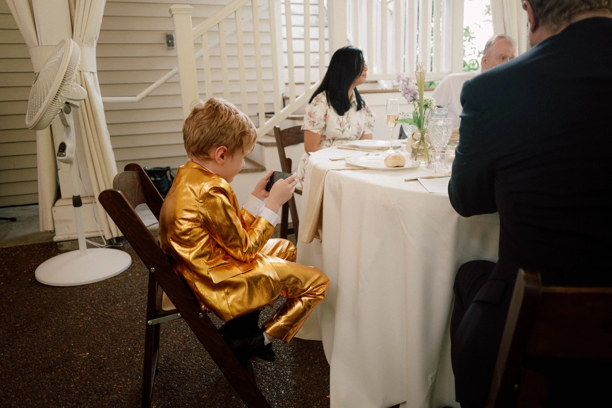 HRD45-boy-playing-video-game-at-wedding-gold-suit.jpg