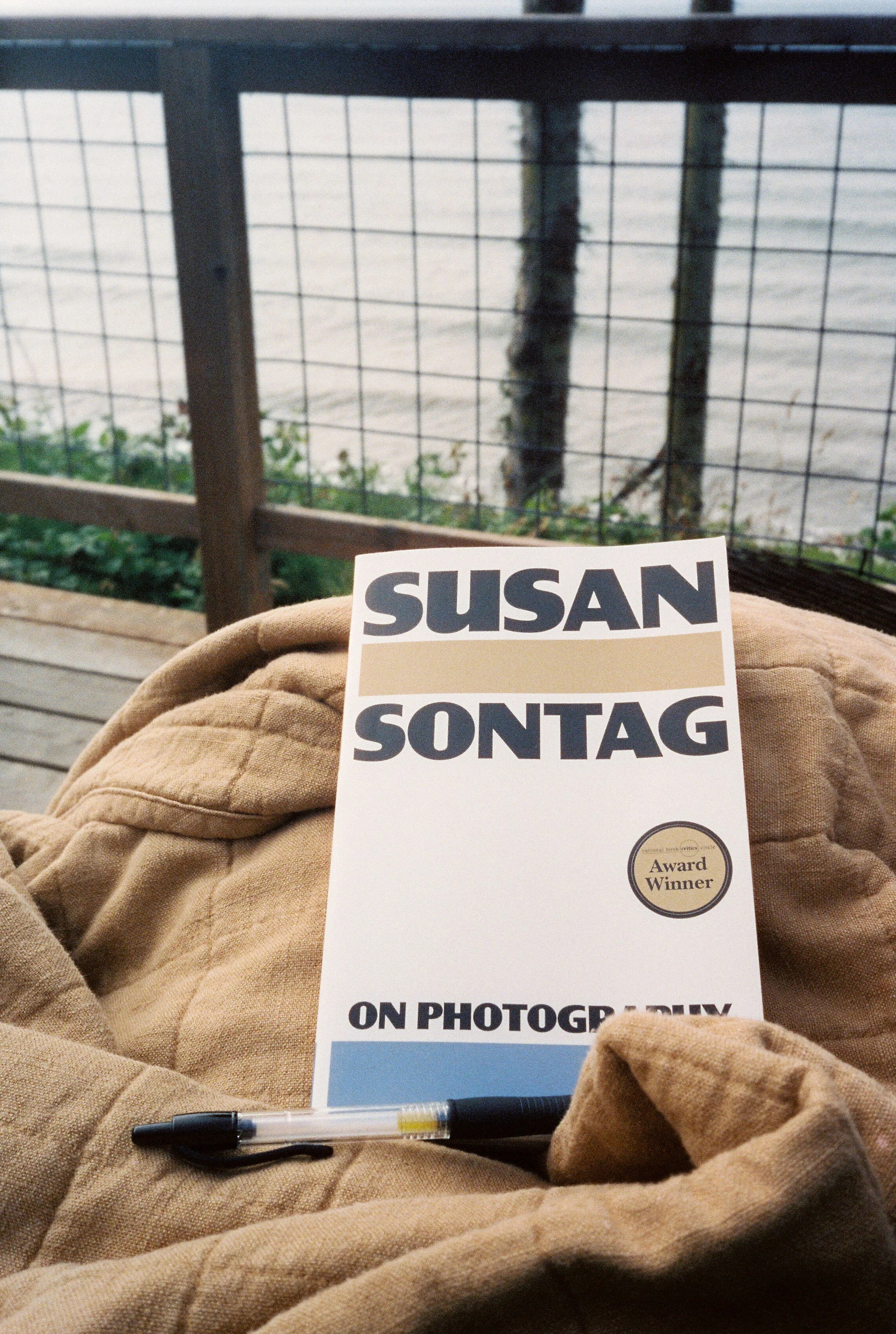 pnw166-on-photography-susan-sontag-with-pen-on-blanket.jpg