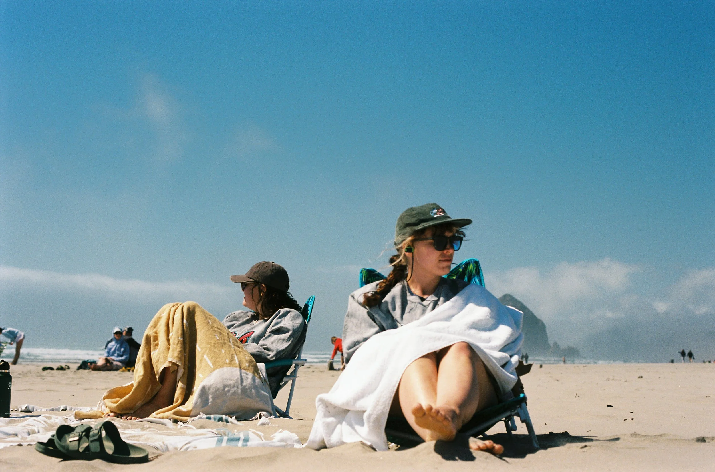 pnw41-women-sitting-on-cannon-beach.jpg
