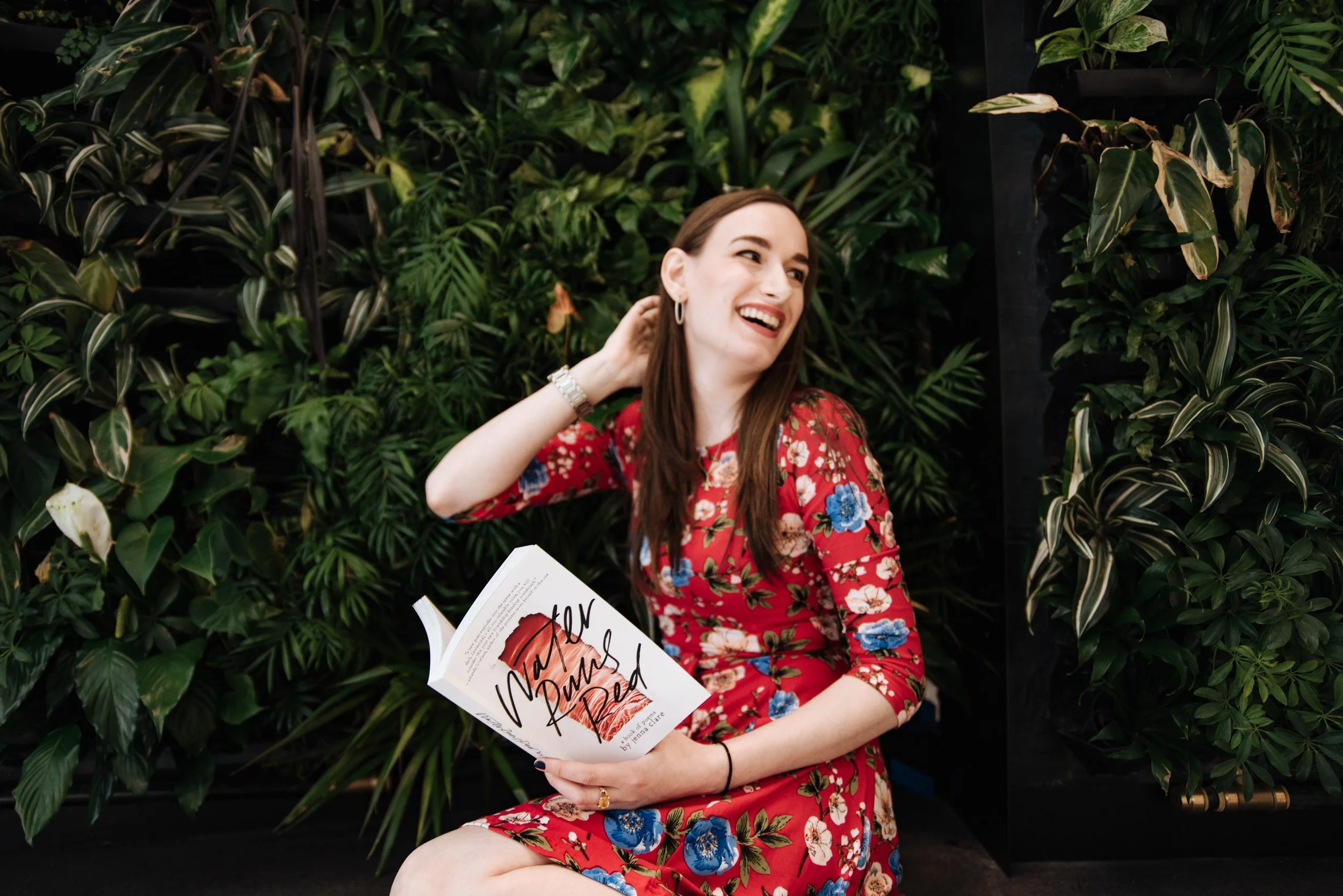 BT253-woman-holding-book-smiling.jpg