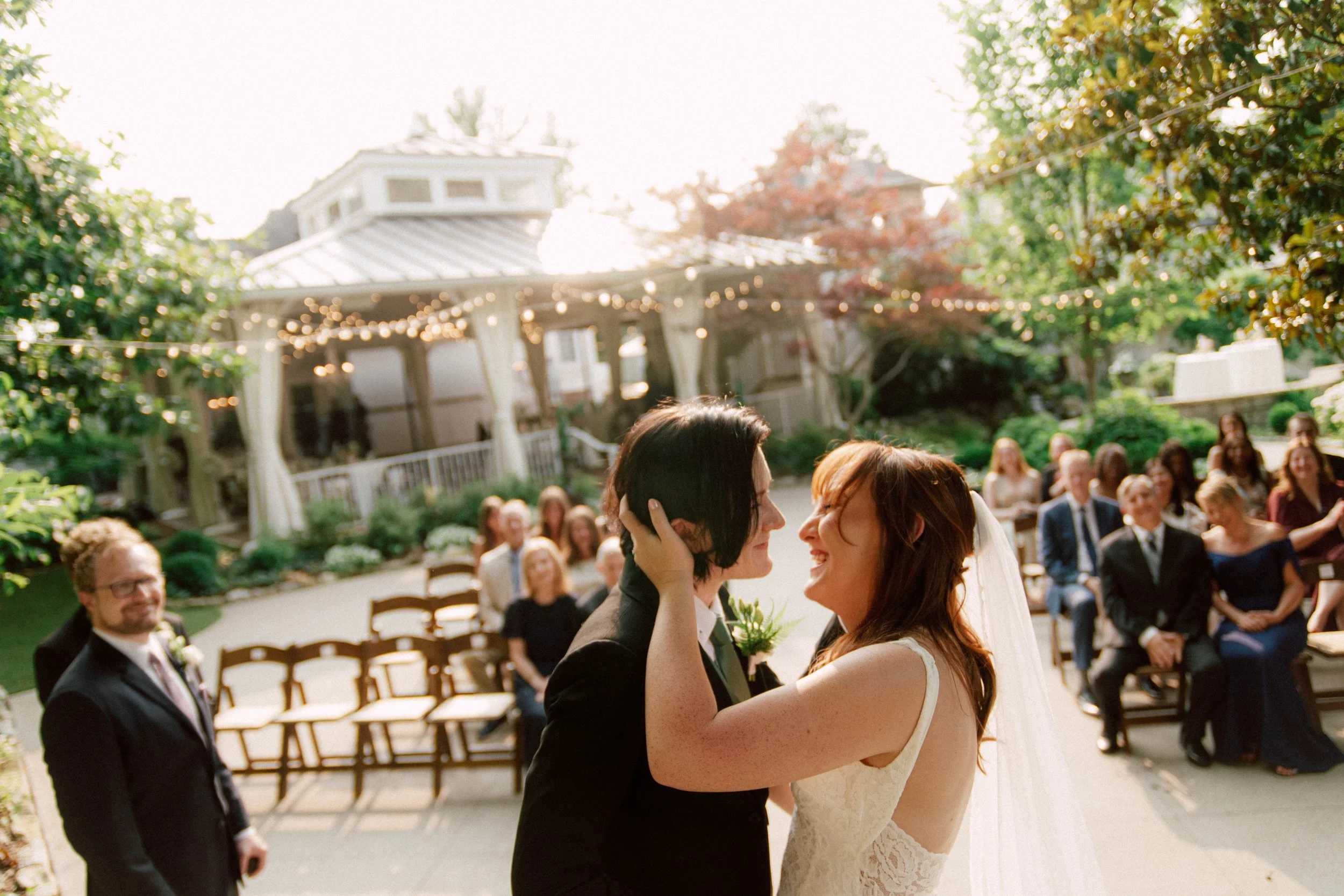HRD32-brides-kissing-at-lgbtq-wedding-laughing.jpg