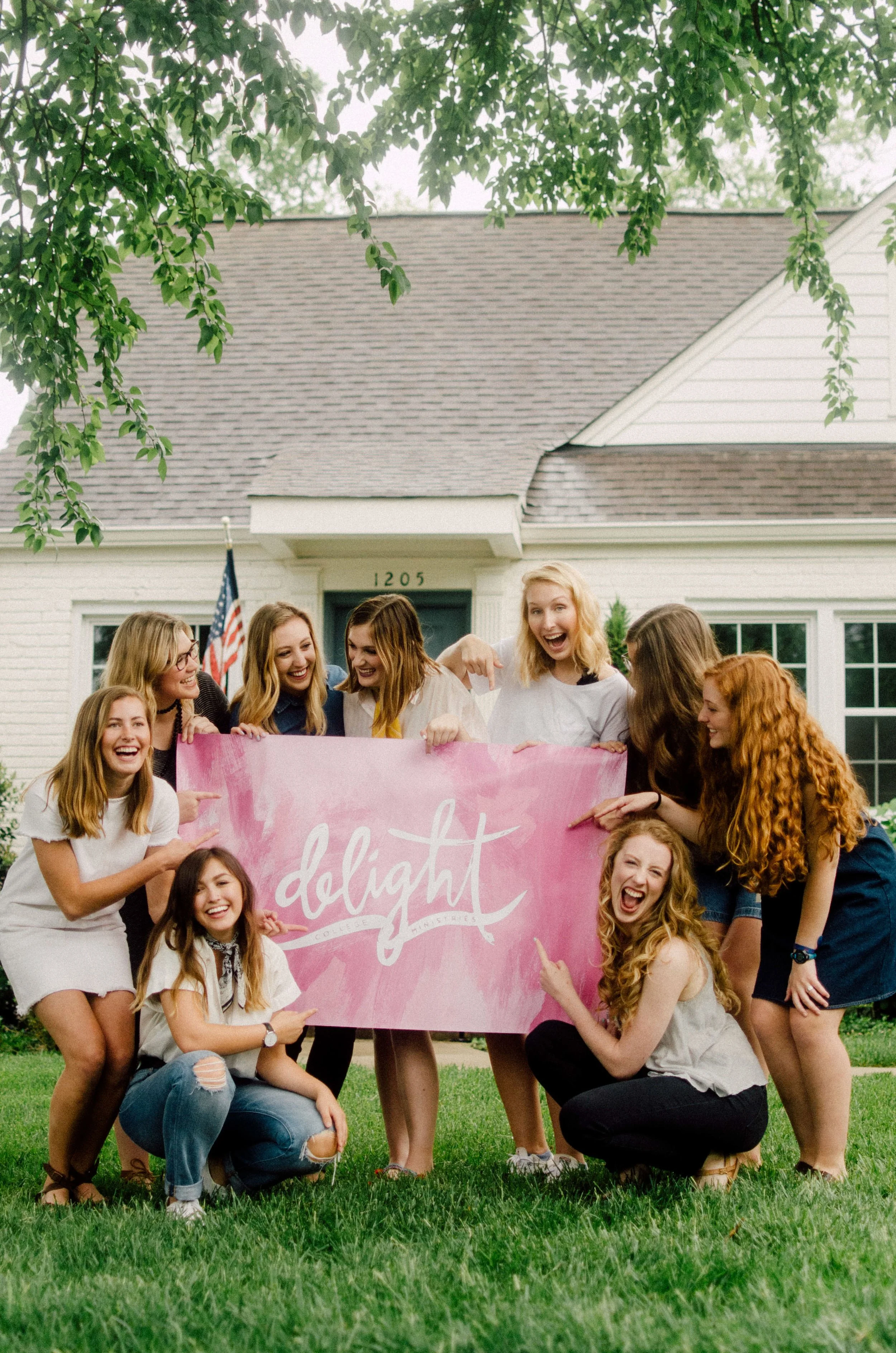 d191-women-outside-holding-pink-delight-banner.jpg