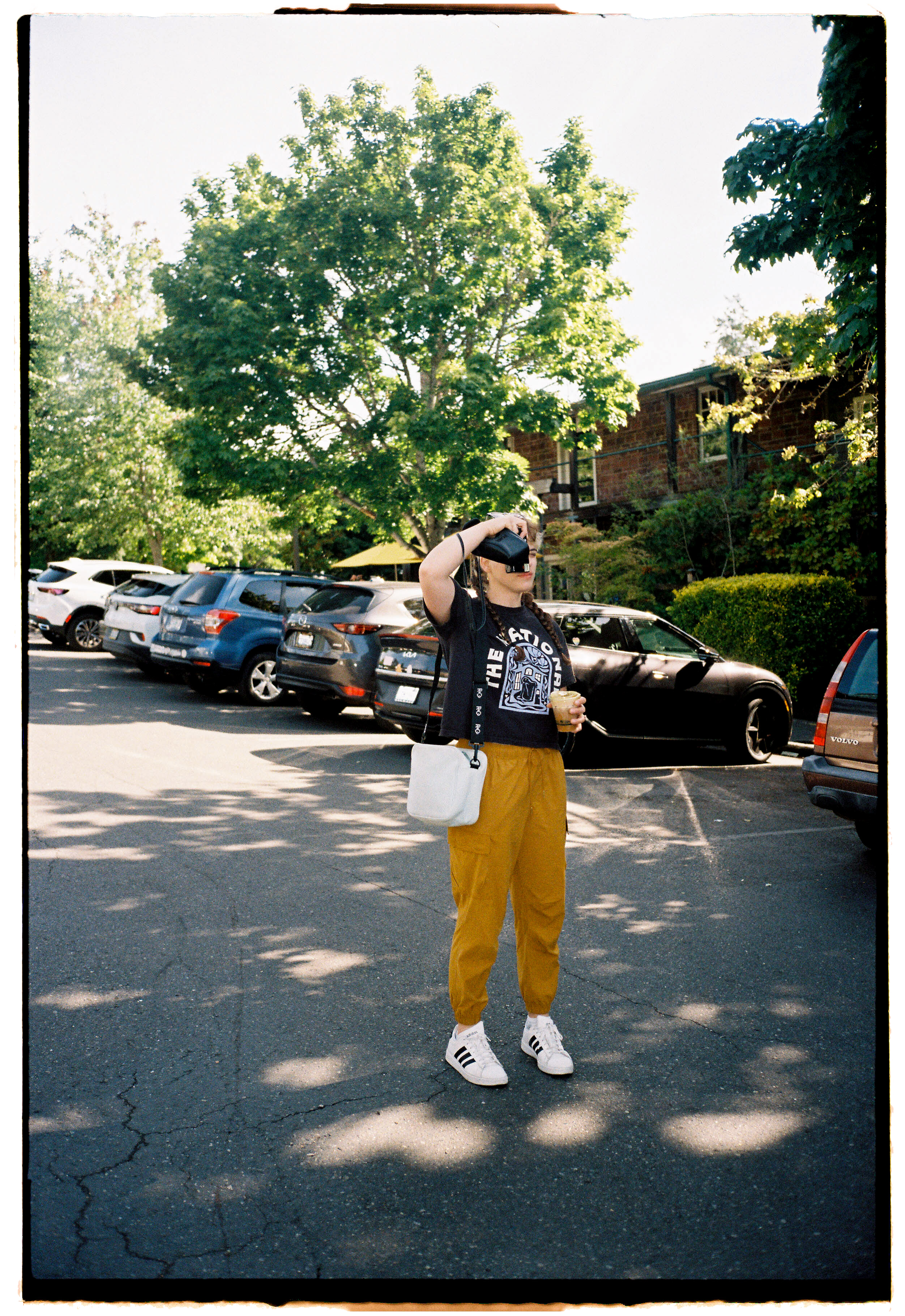 pnw212-woman-taking-photo-with-camera-in-shadow.png