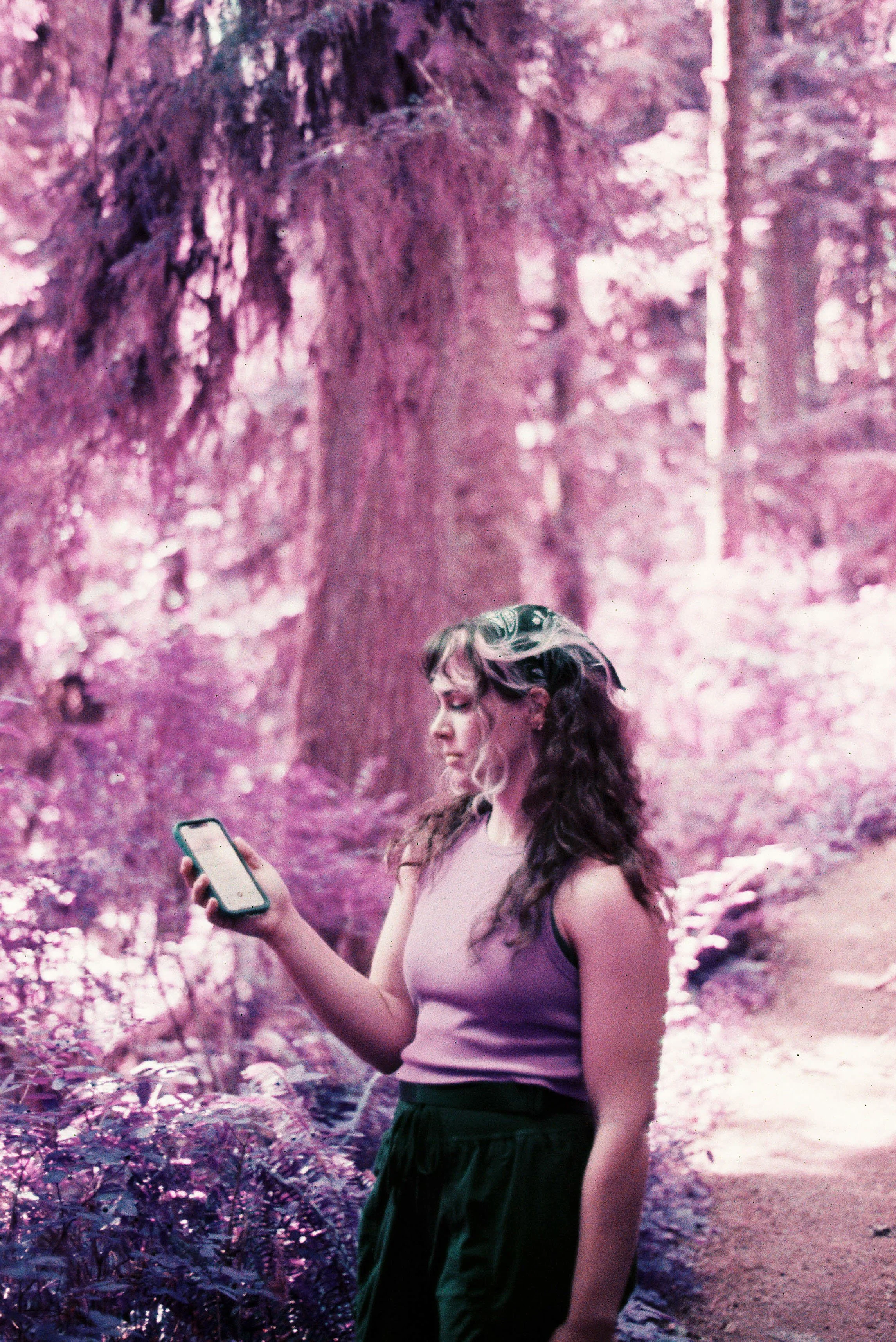 pnw111-woman-holding-phone-on-nature-trail-lomo-purple.jpg