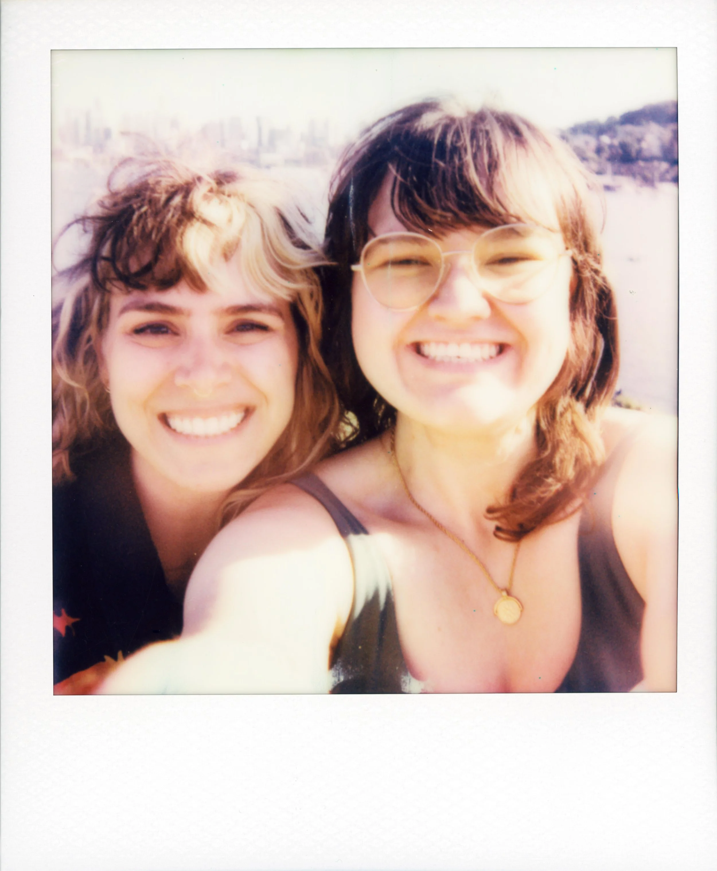 polaroid-two-women-smiling-selfie-glasses-necklace.jpg