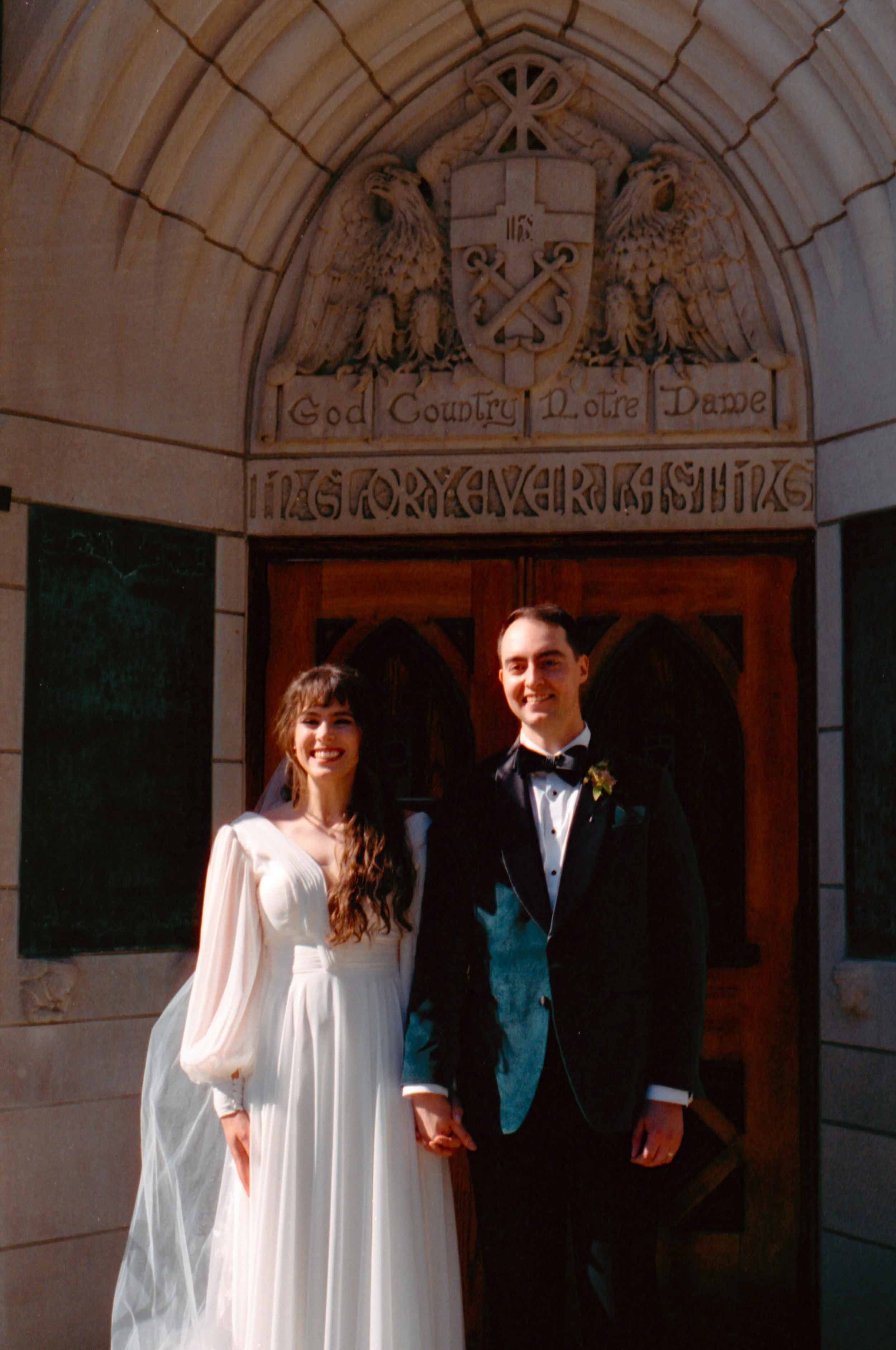 LBW25-bride-groom-holding-hands-notre-dame-university.jpg